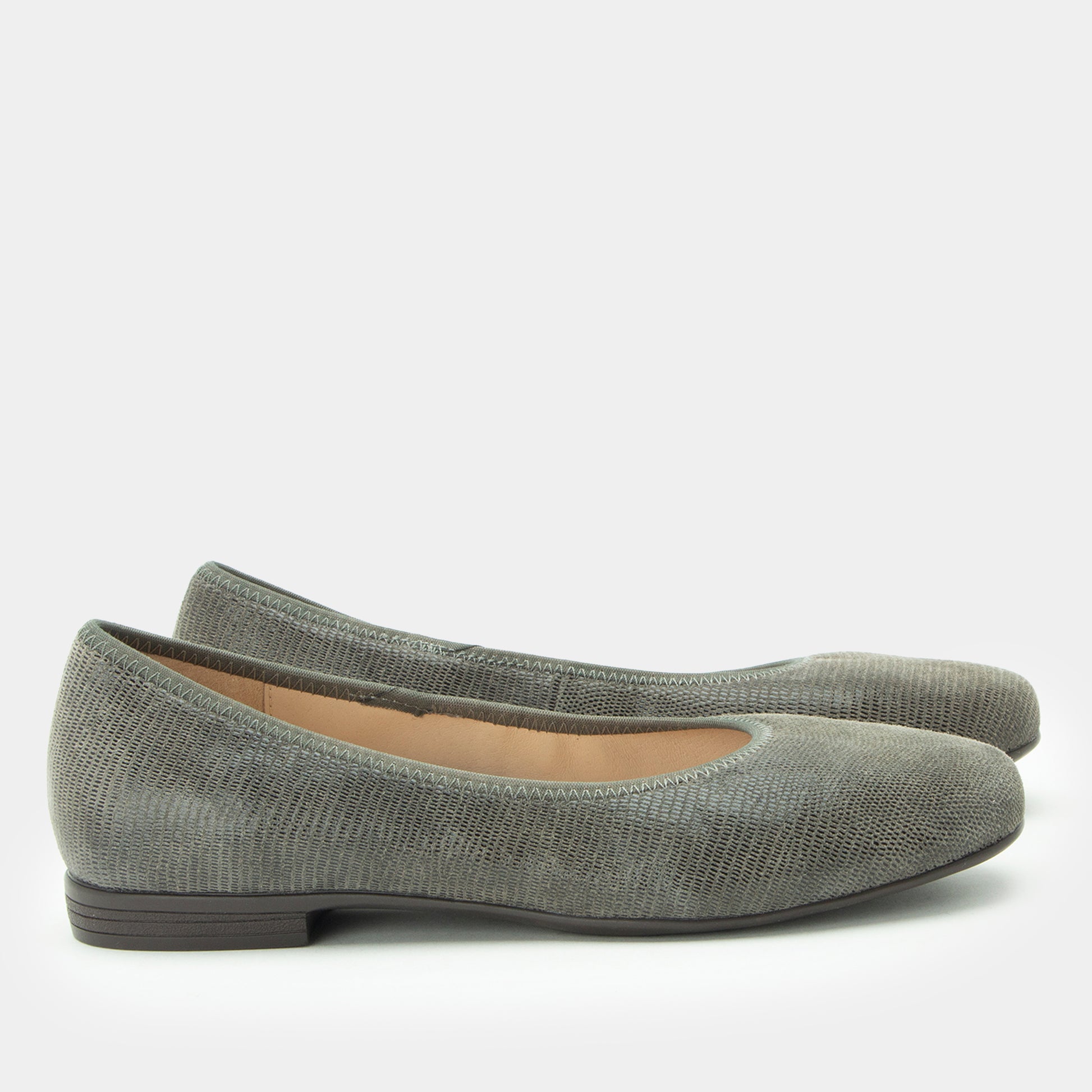Pair of gray flat shoes on a white background