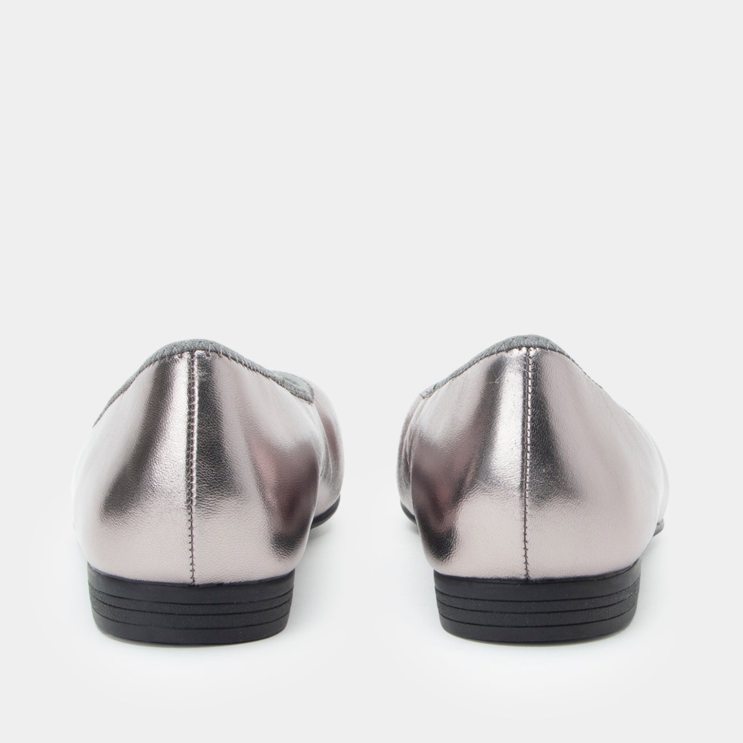 Pair of silver metallic loafers on a white background