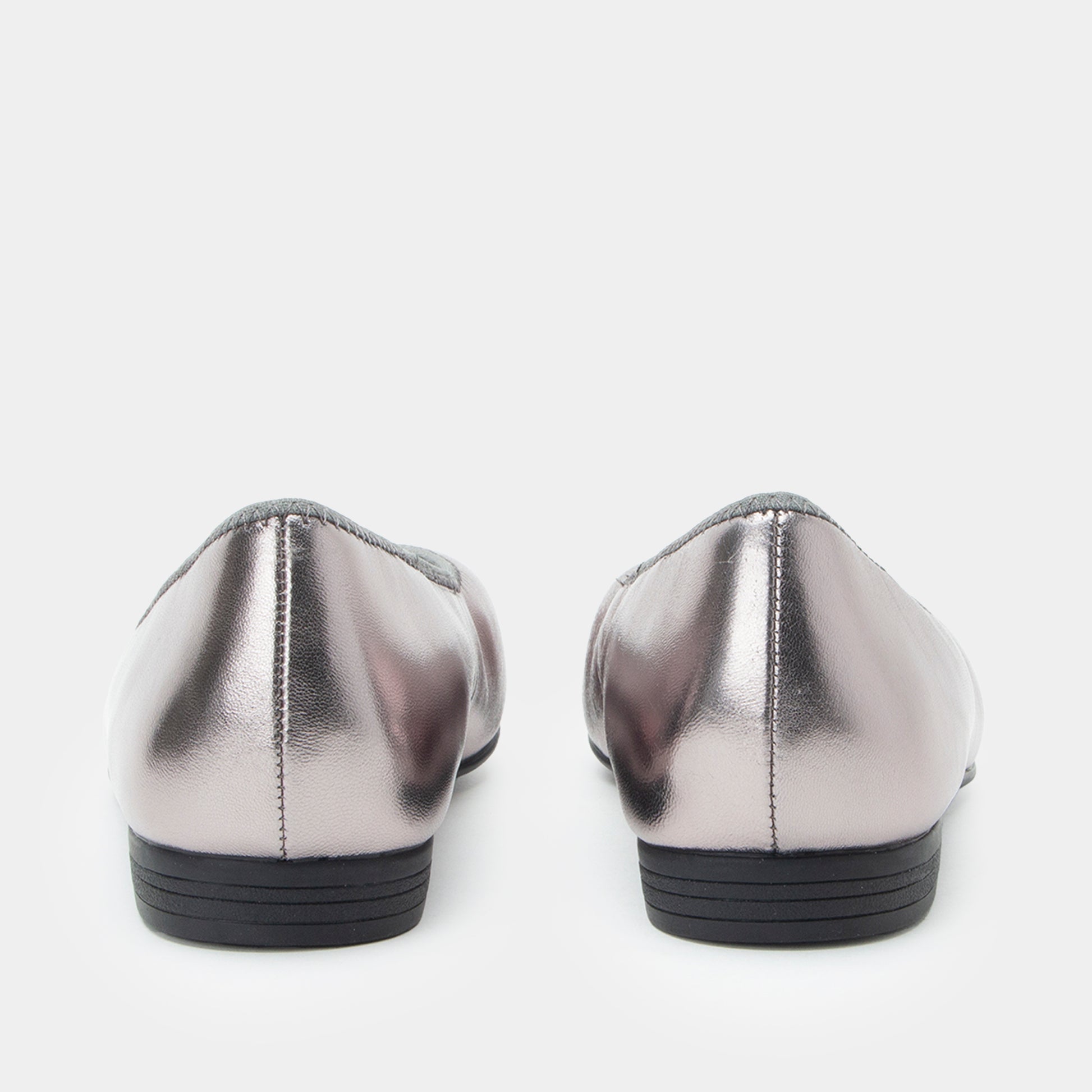 Pair of silver metallic loafers on a white background