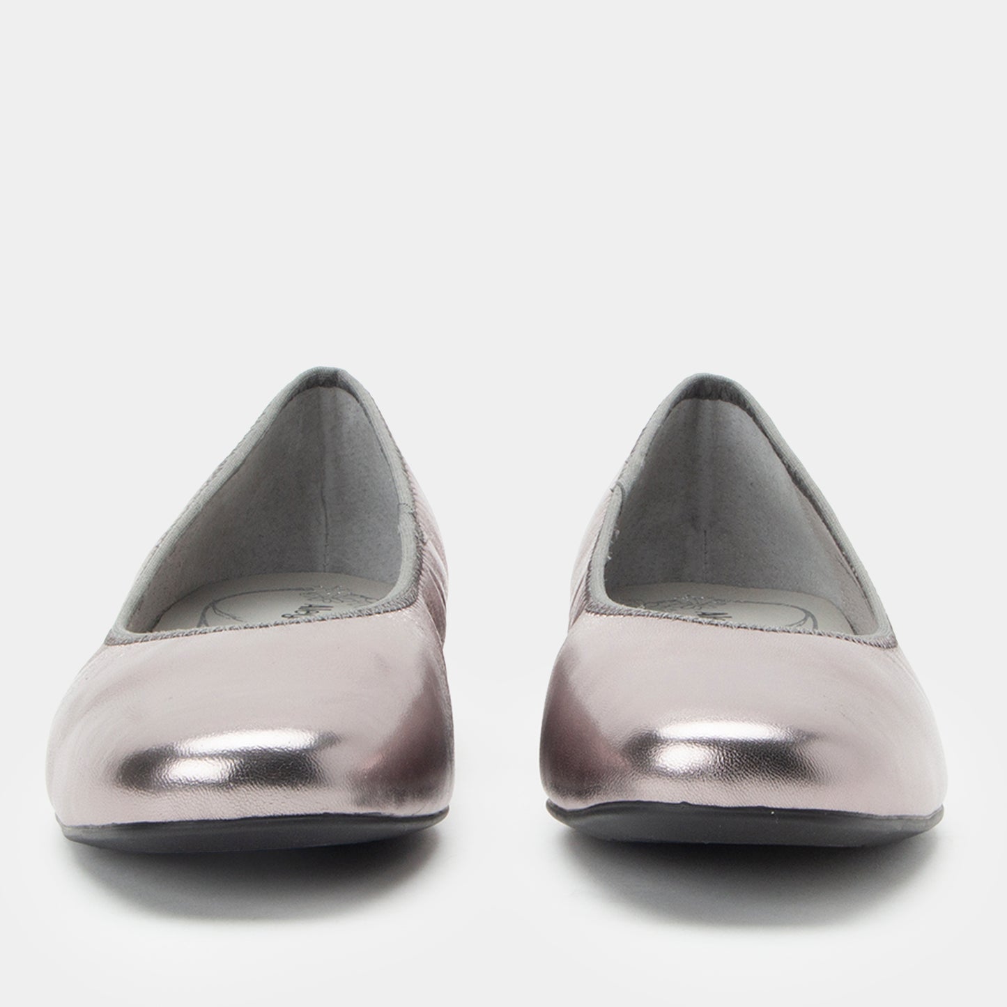 Pair of silver metallic flats on a white background