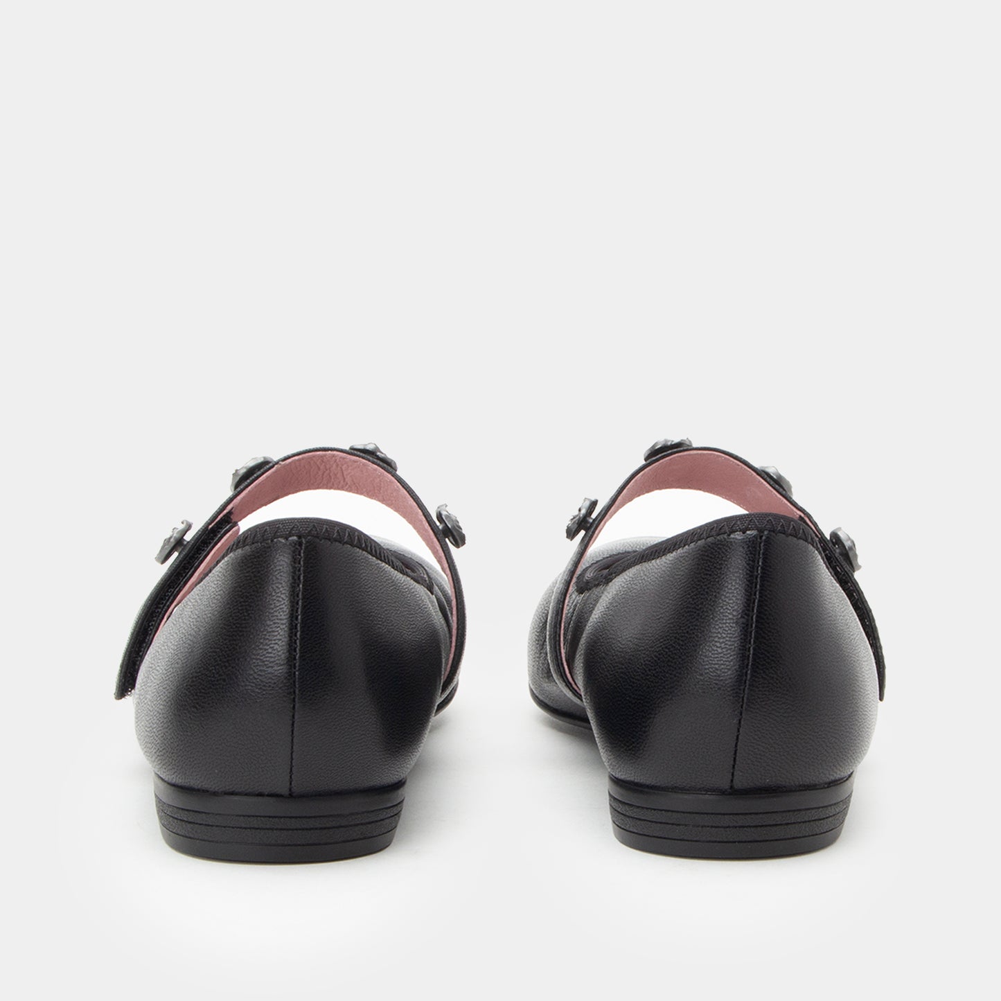 Black leather shoes with brown accents on a white background
