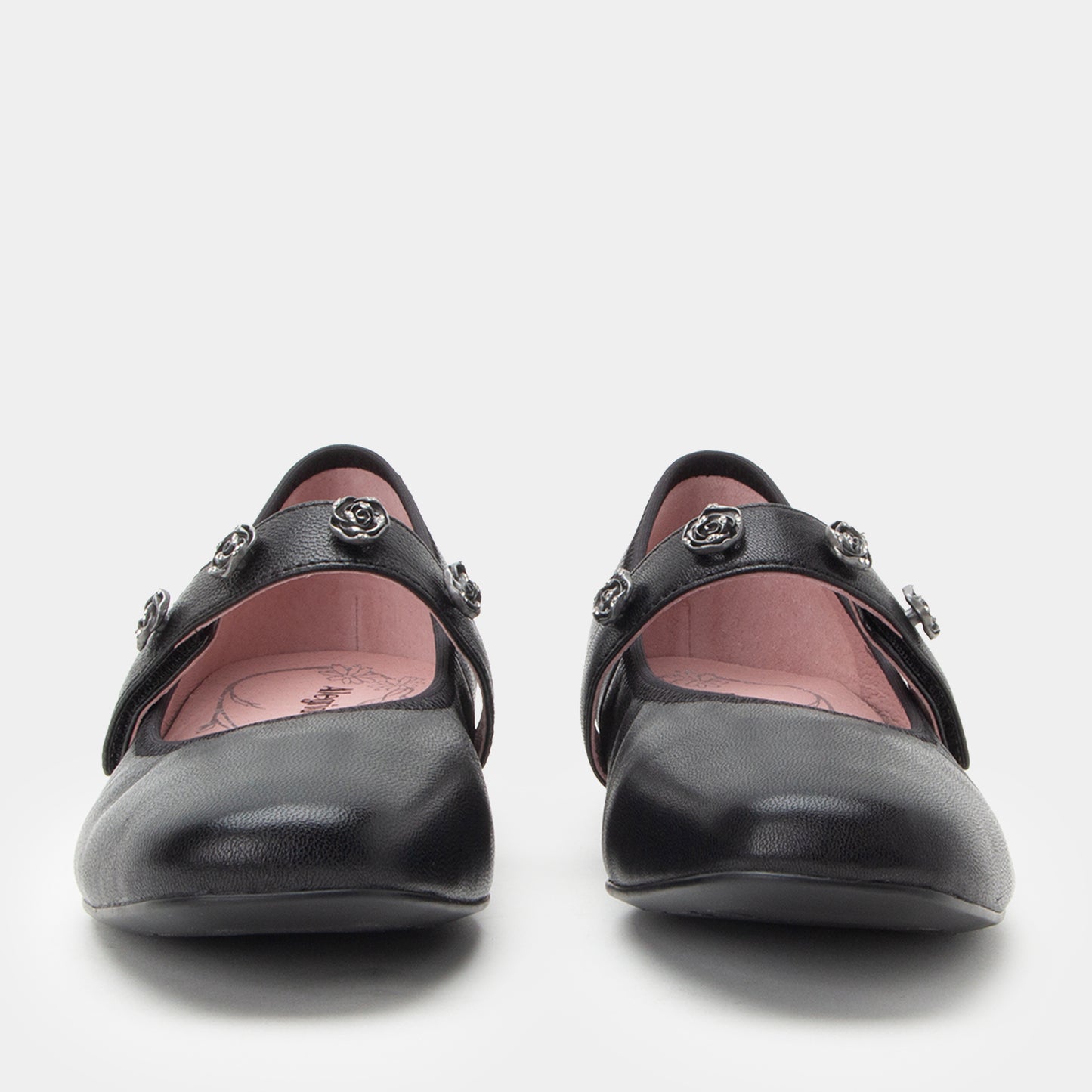 Pair of black shoes with decorative elements on a white background
