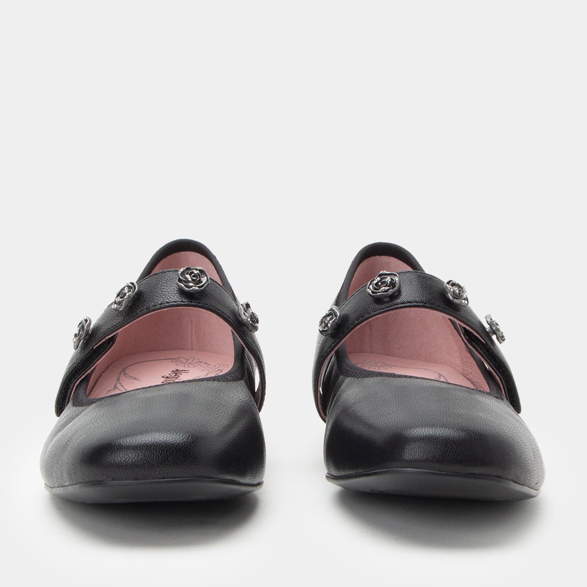 Pair of black shoes with decorative elements on a white background