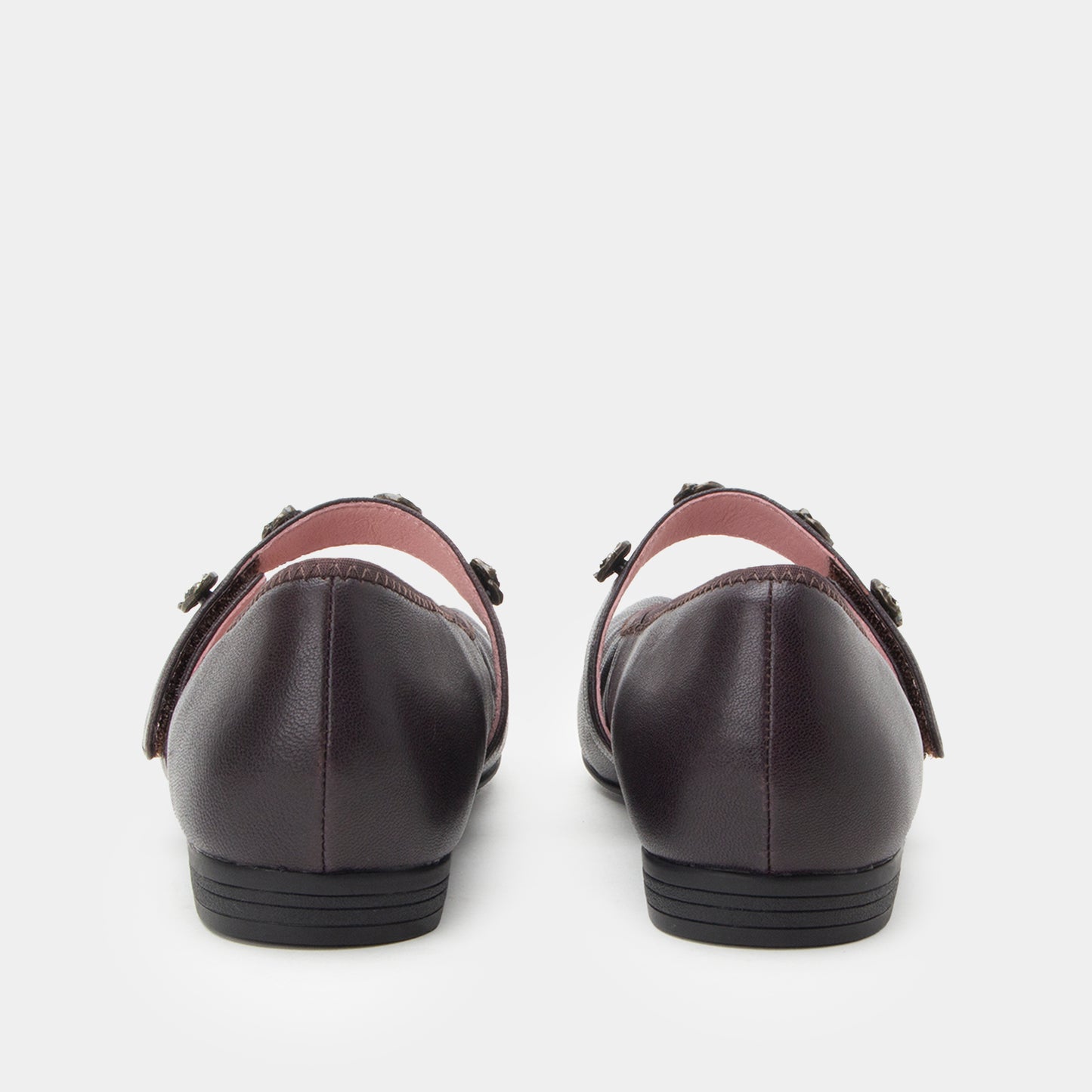 Pair of black leather shoes with brown accents on a white background