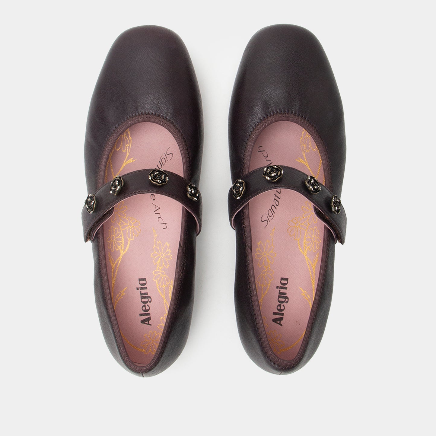 Pair of black shoes with gold accents on a white background