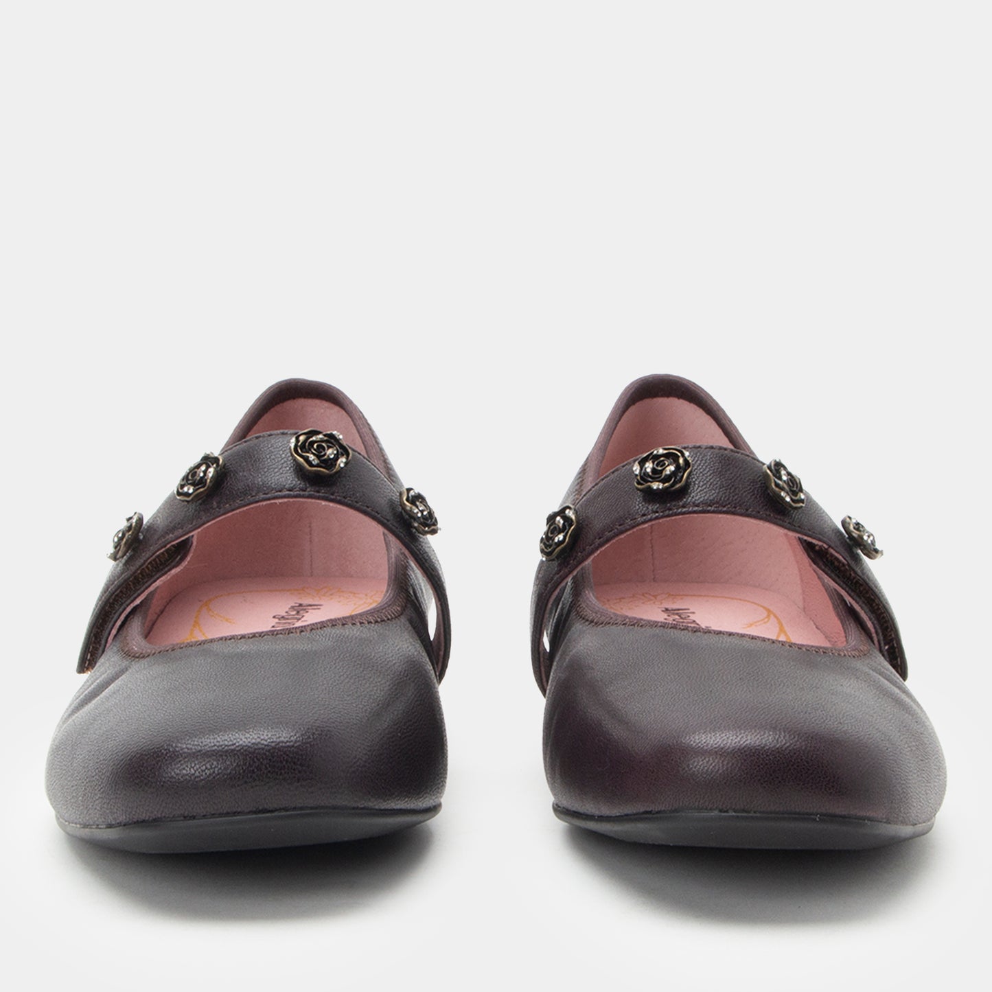 Pair of black shoes with decorative elements on a white background