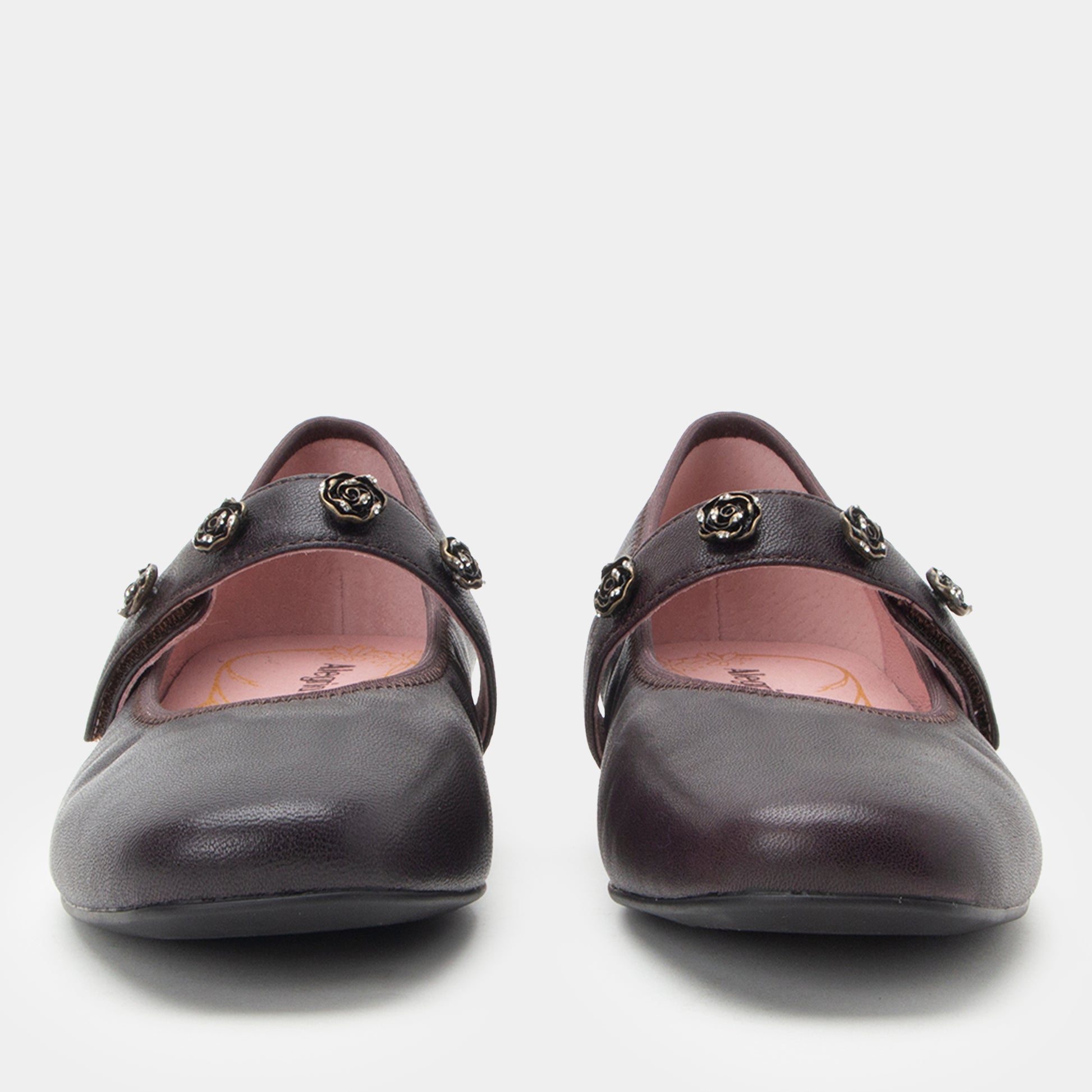 Pair of black shoes with decorative elements on a white background