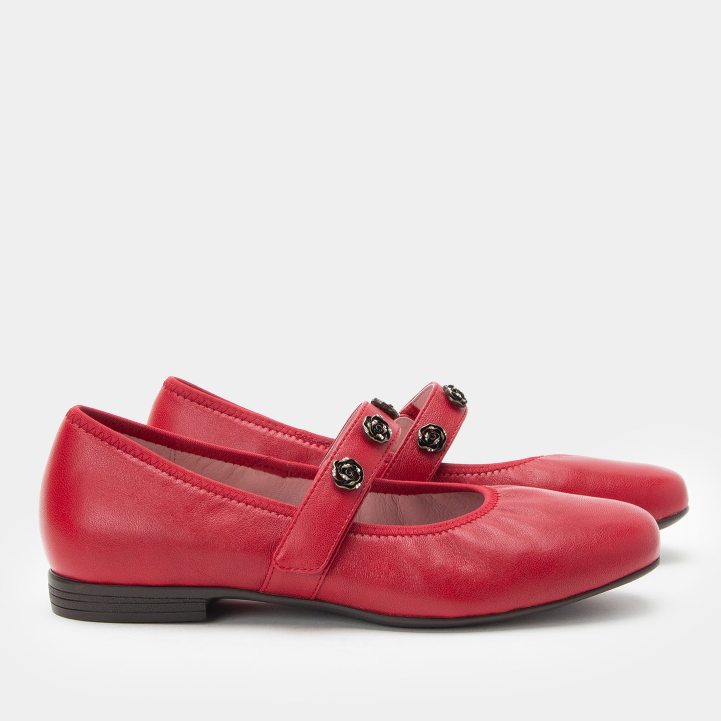 Red shoes with a strap and buckles on a white background