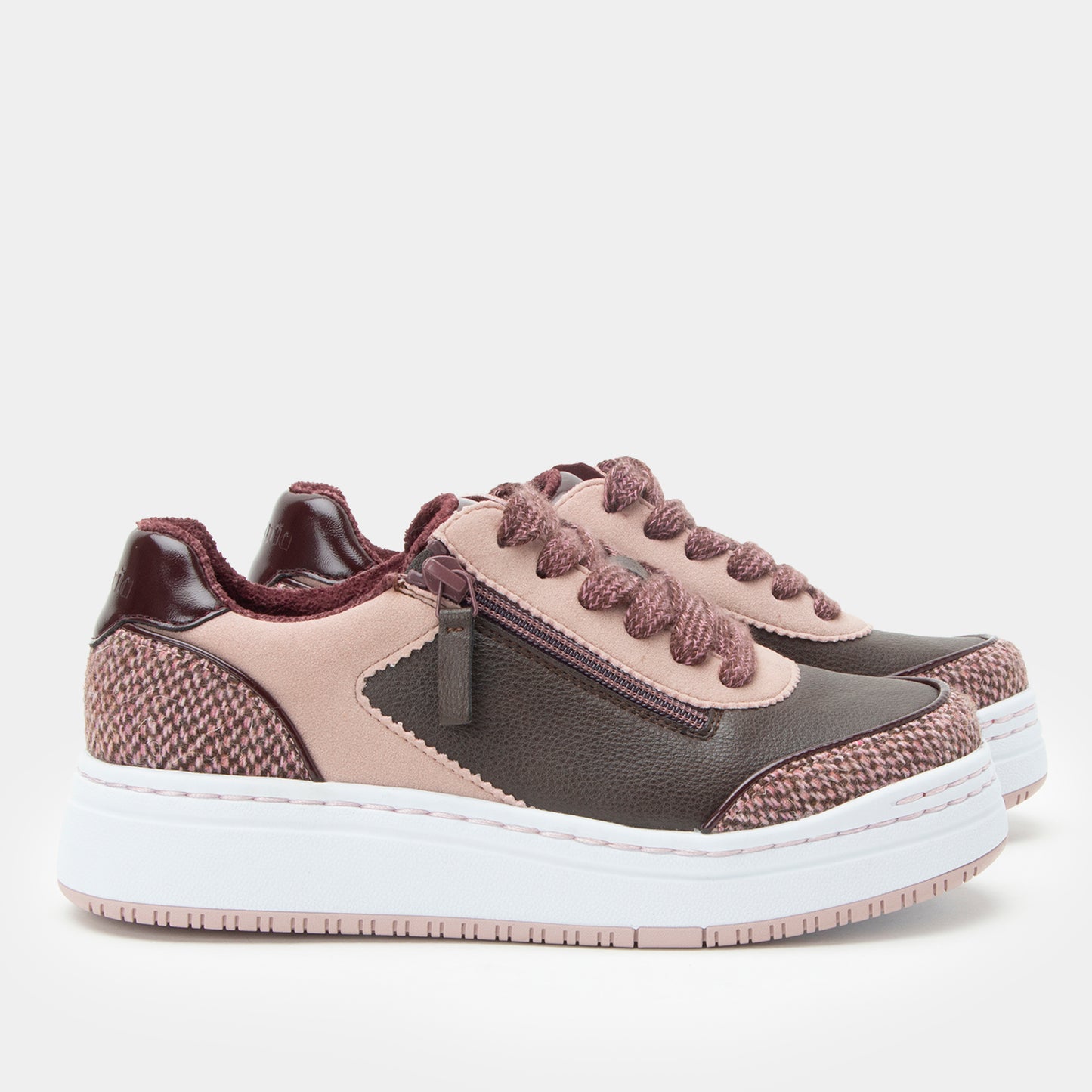 Pair of brown and black sneakers on a white background