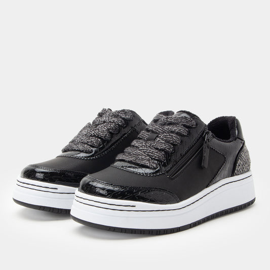 Black sneakers with white soles on a light gray background