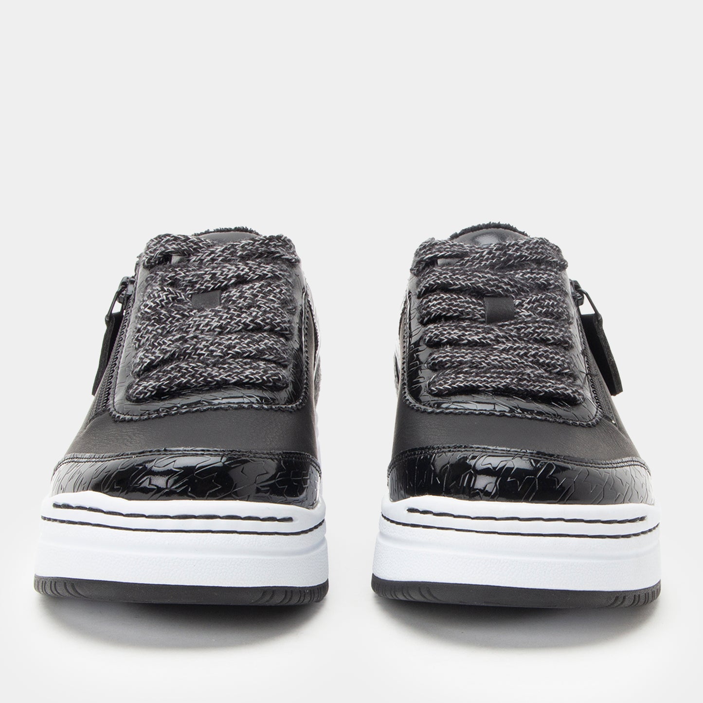 Black and gray sneakers with white soles on a light gray background