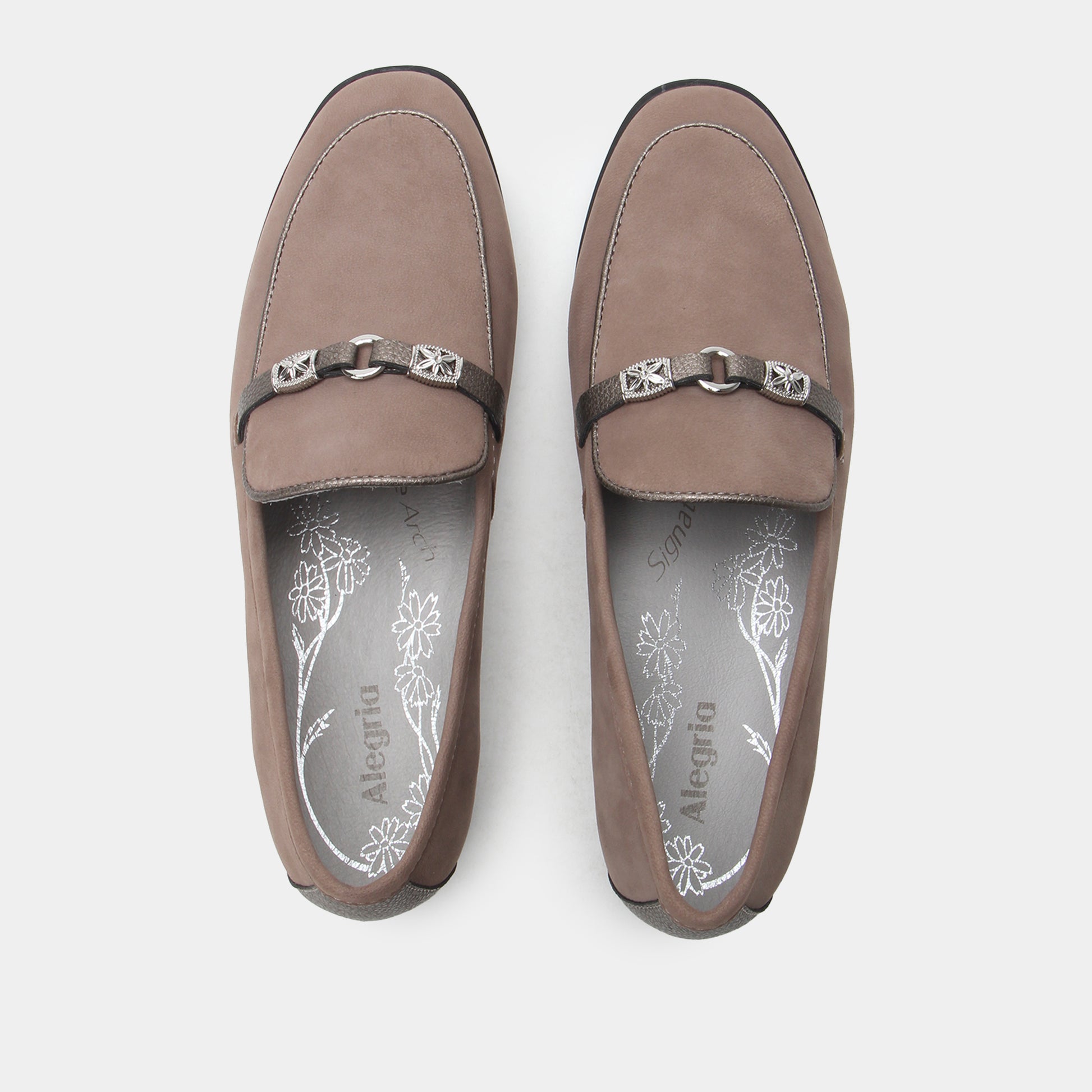 Pair of brown loafers with decorative straps on a white background