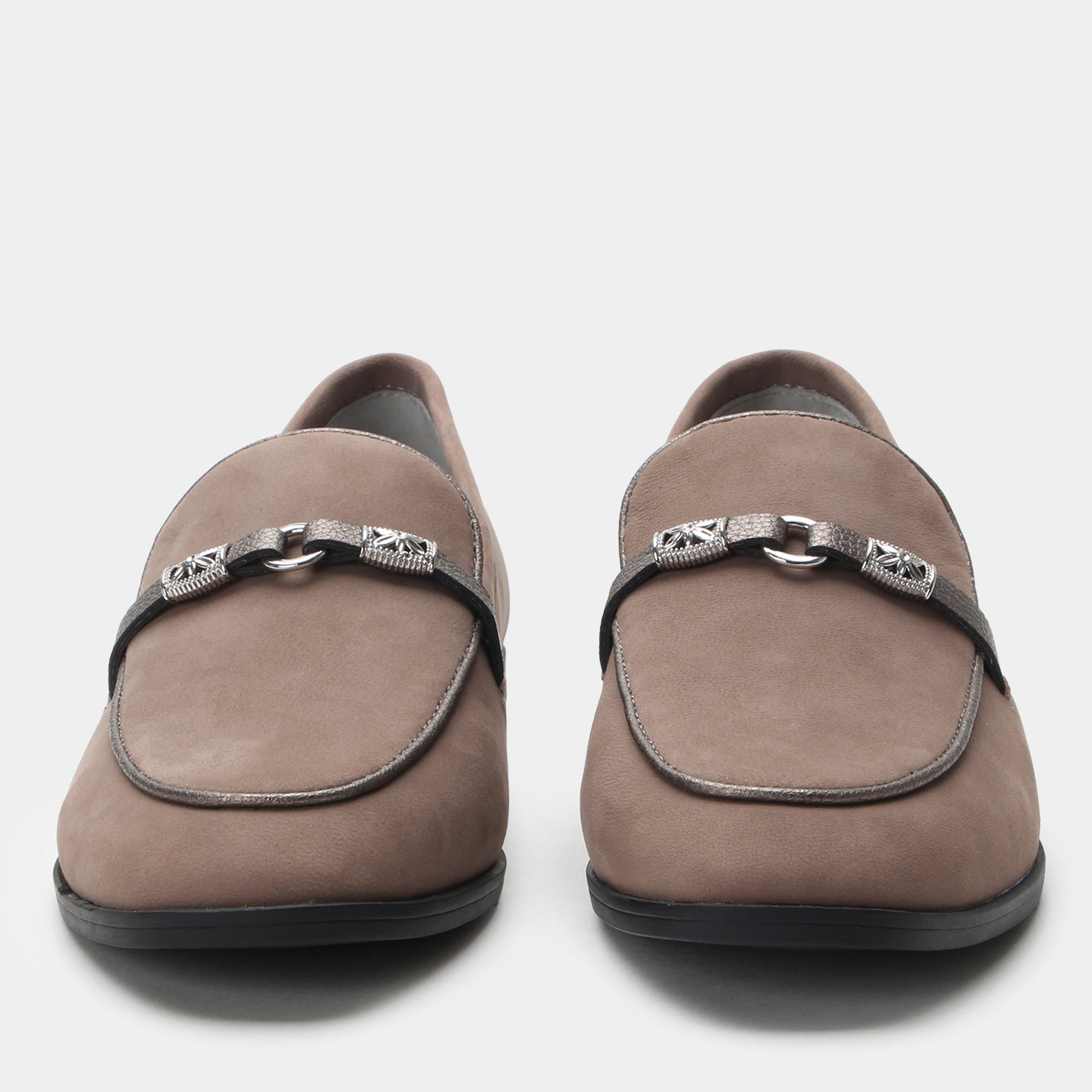 Pair of brown loafers with decorative straps on a white background