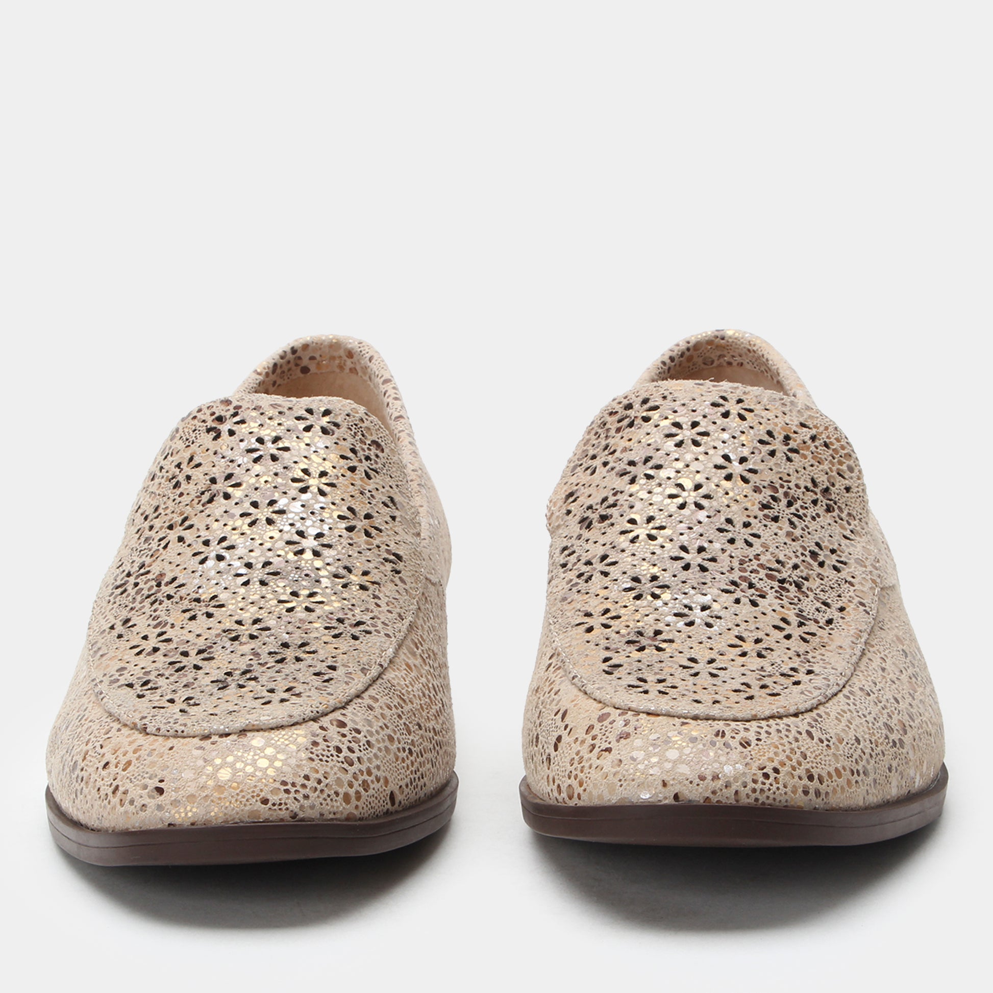 Pair of beige perforated loafers on a white background