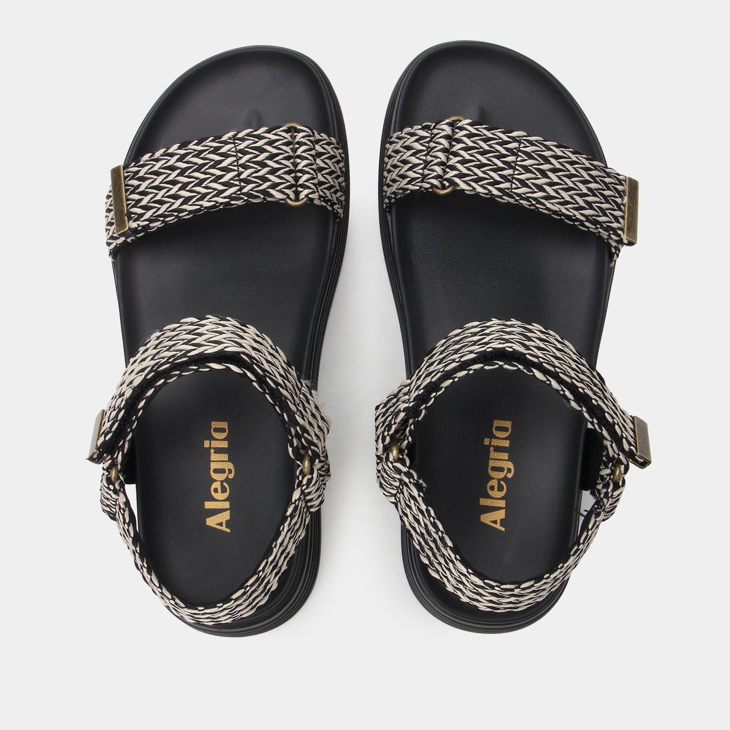Pair of black sandals with braided straps on a white background