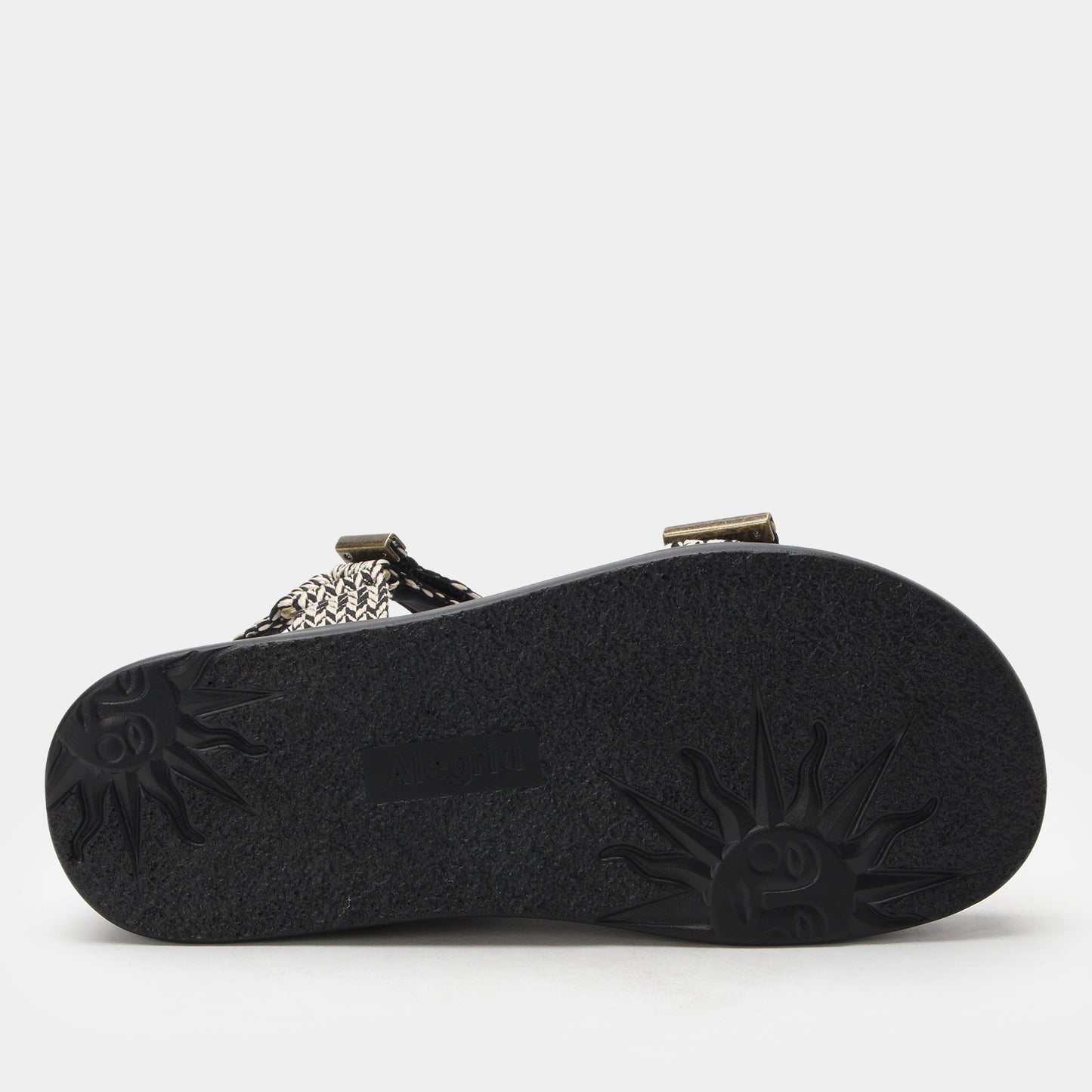 Black sandal sole with brand logo on a light gray background