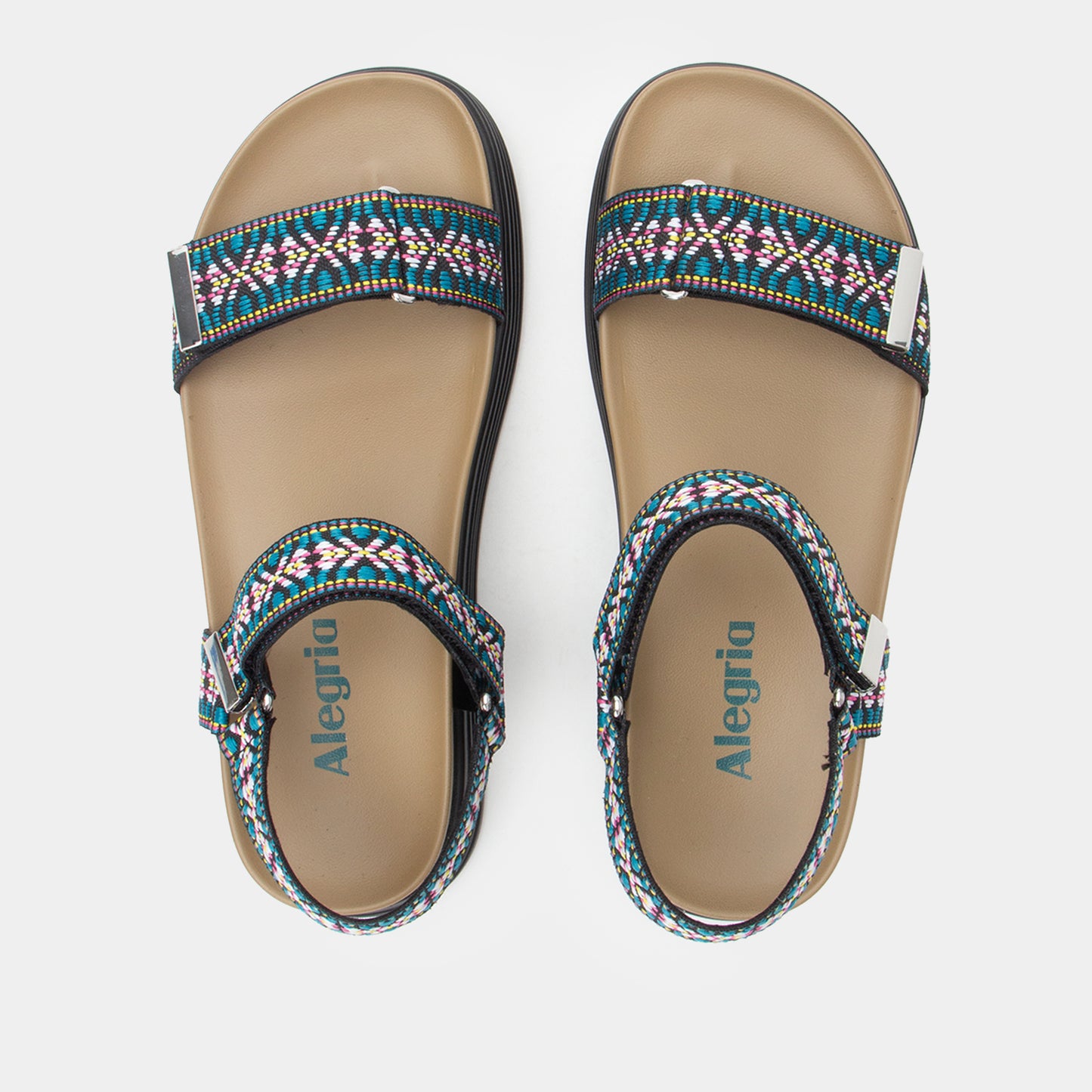 Pair of Alegria sandals with colorful straps on a light gray background