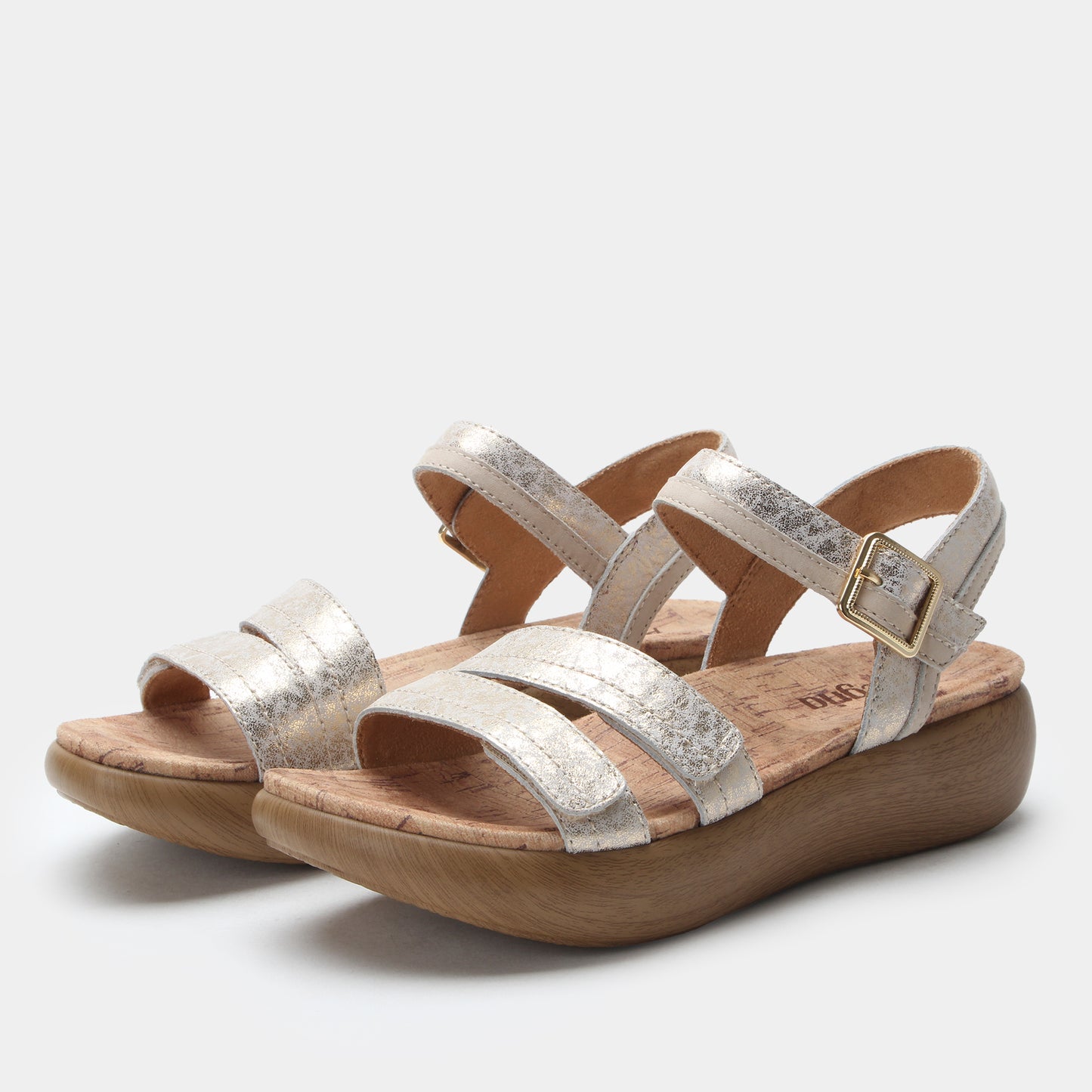 Pair of silver strappy sandals on a light gray background