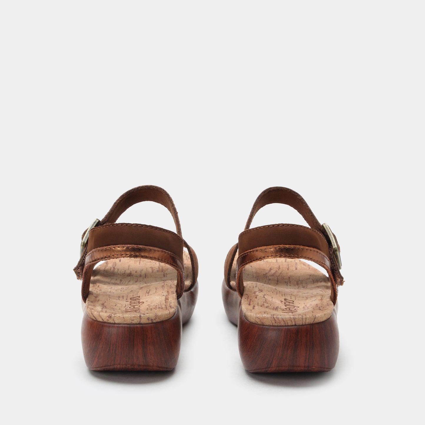 Pair of brown sandals with cork insole on a white background