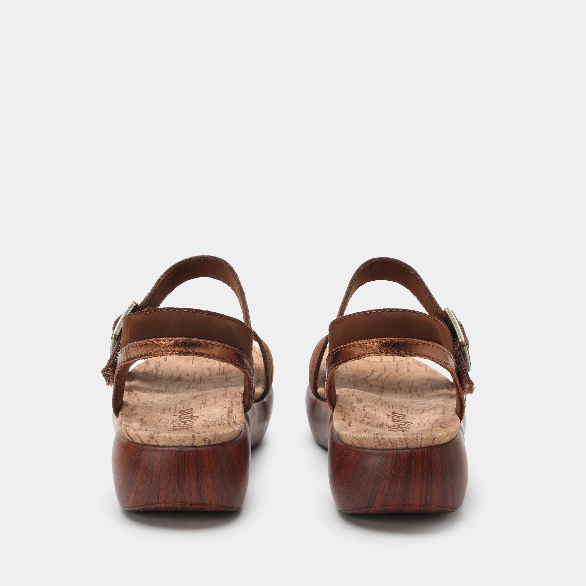 Pair of brown sandals with cork insole on a white background