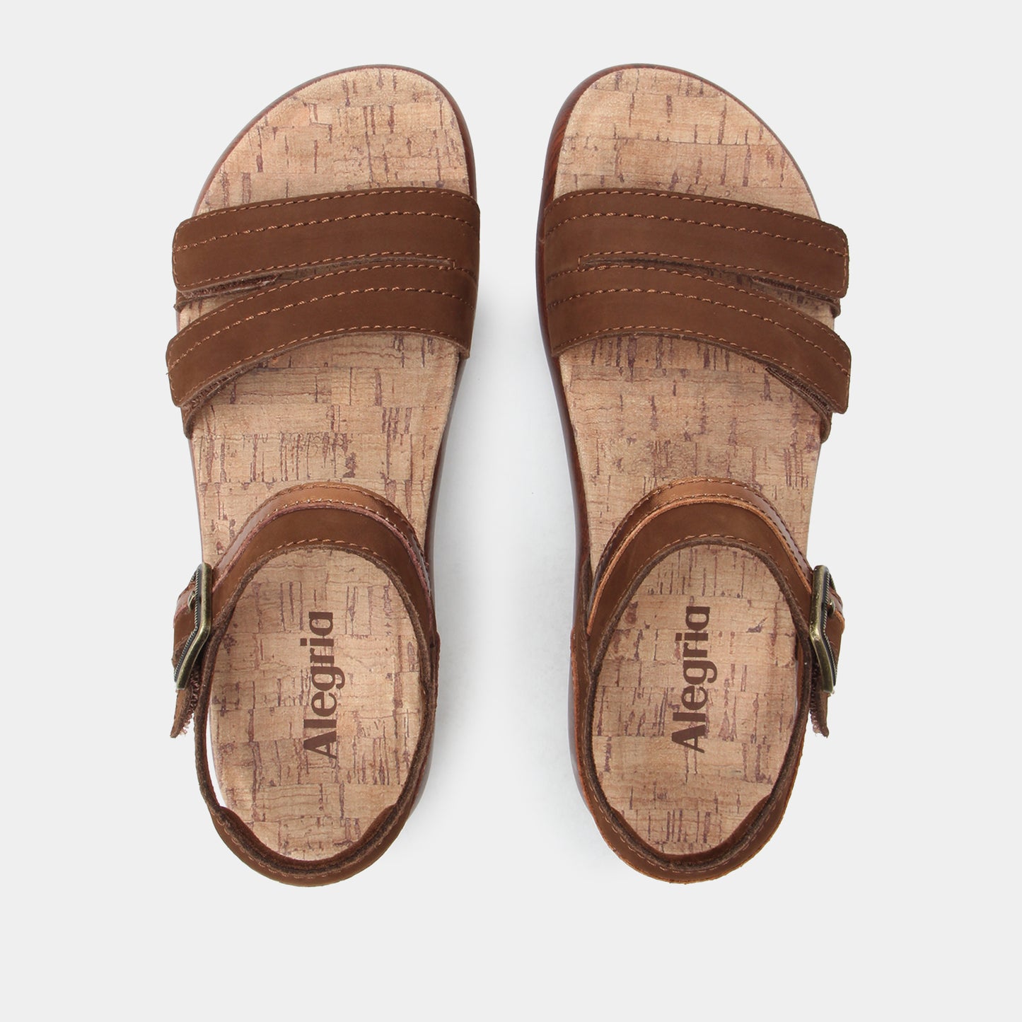 Pair of brown sandals with cork sole on a white background
