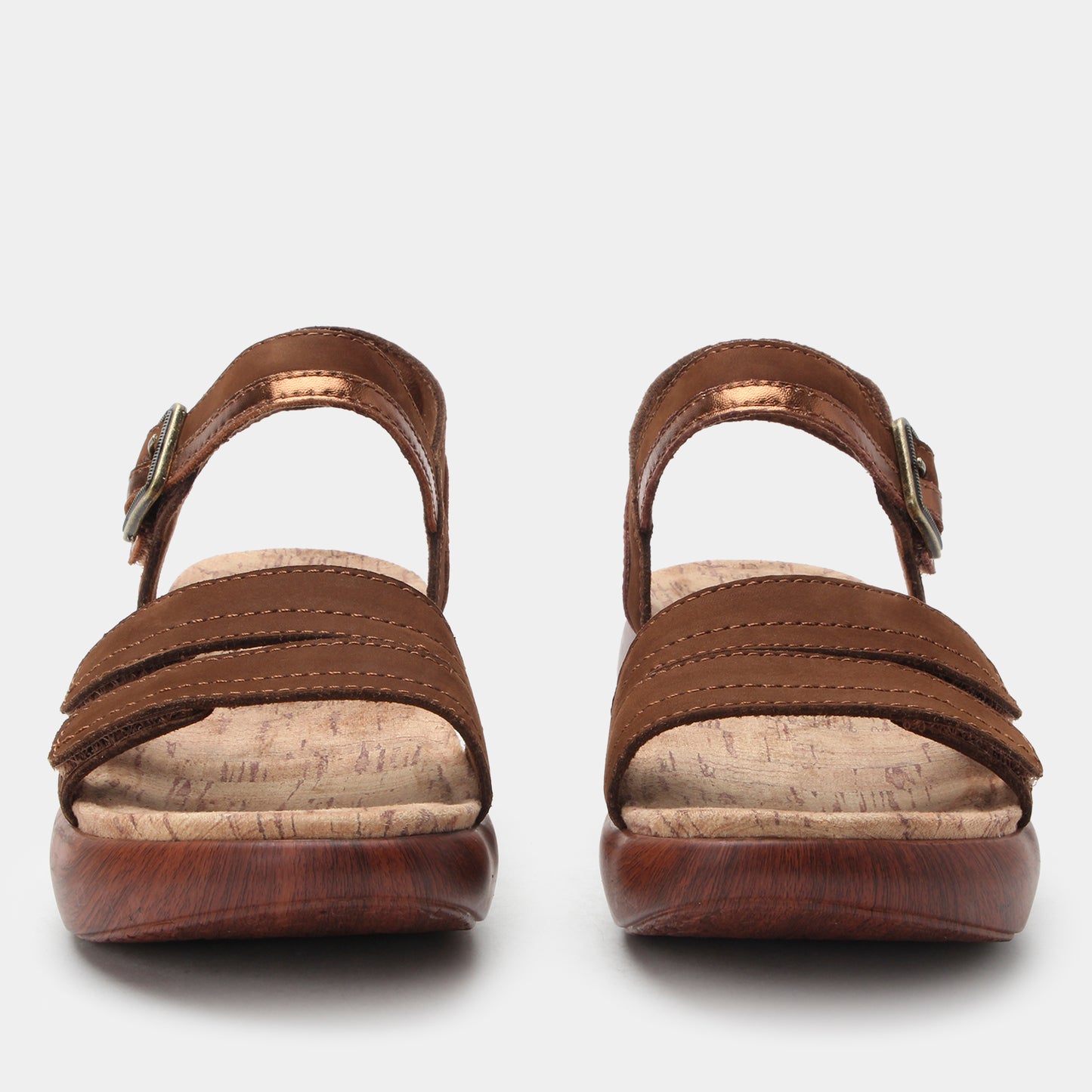 Pair of brown sandals with cork insole on a white background