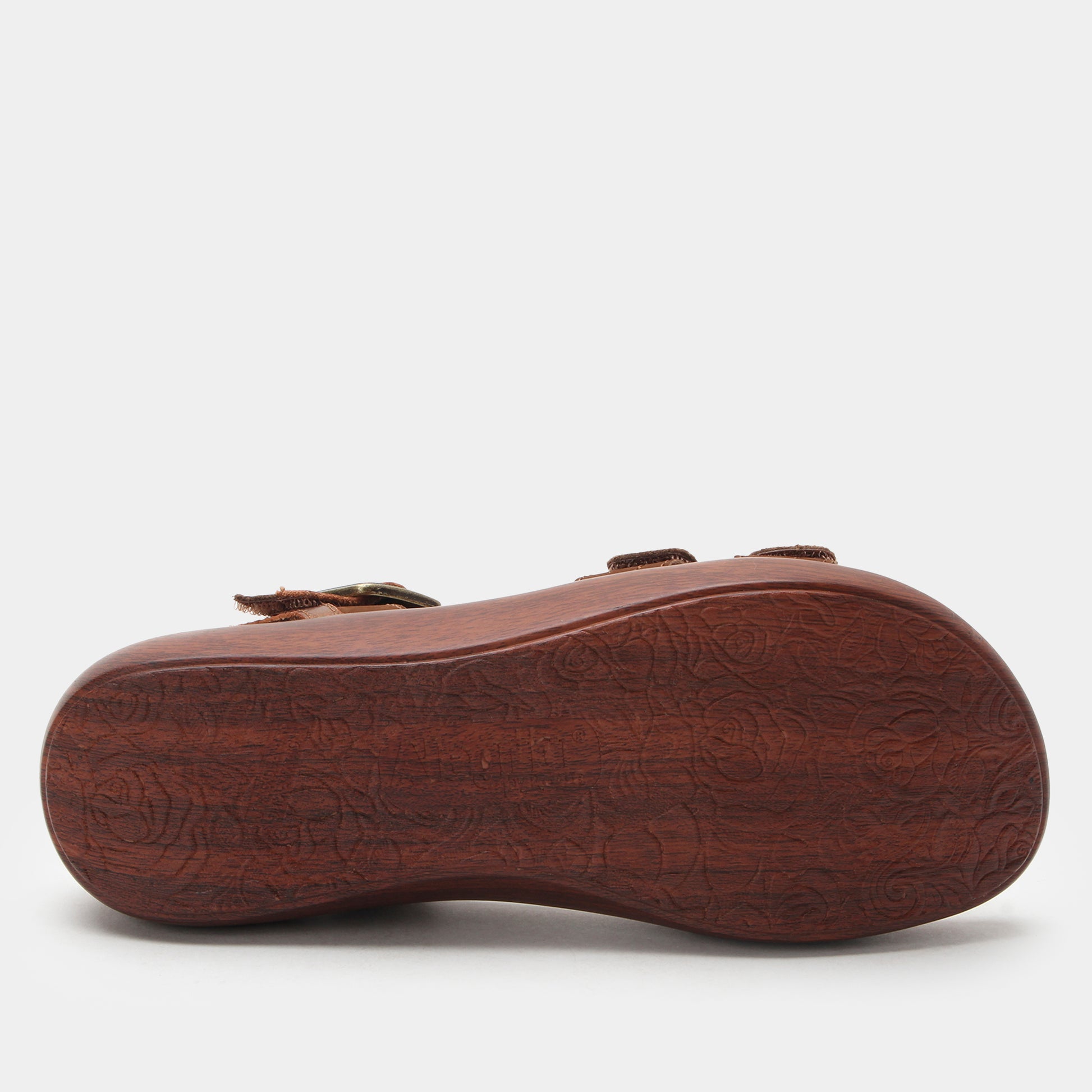 Brown sandal sole with embossed design on a white background