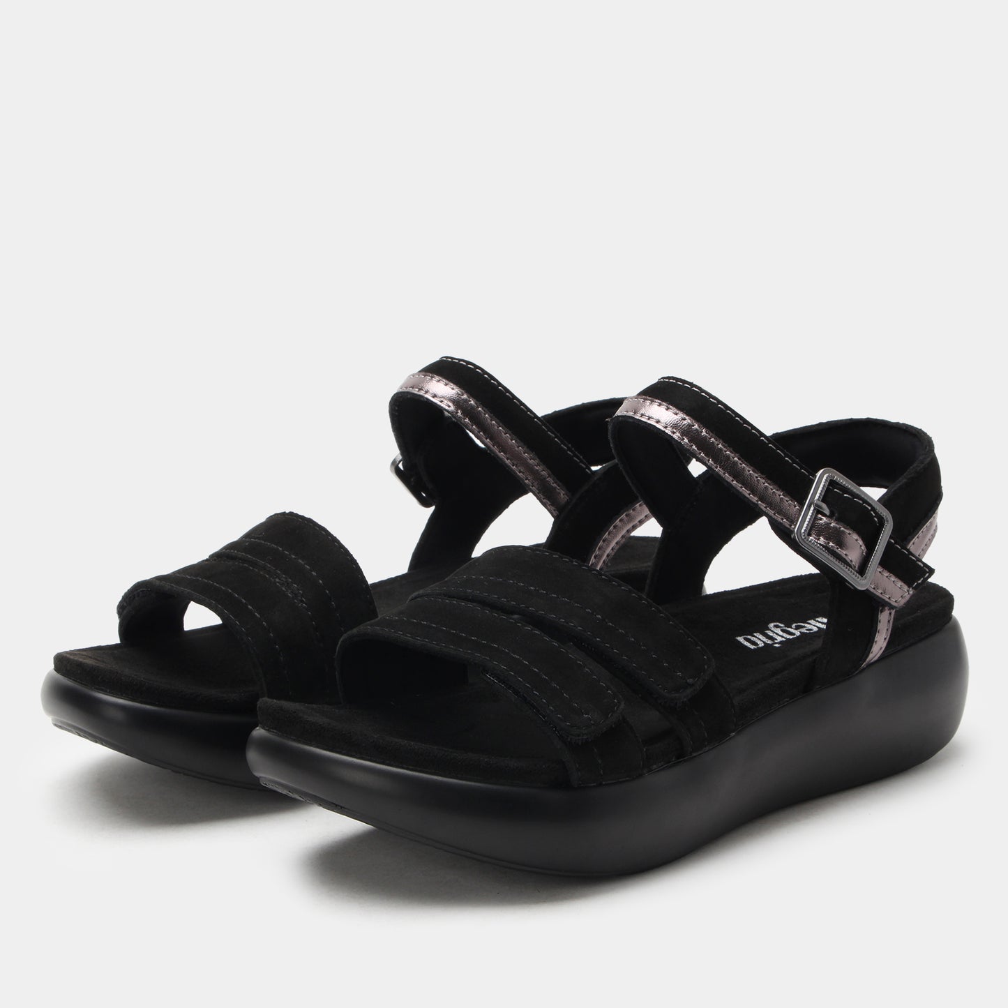 Black sandals with multiple straps on a light gray background