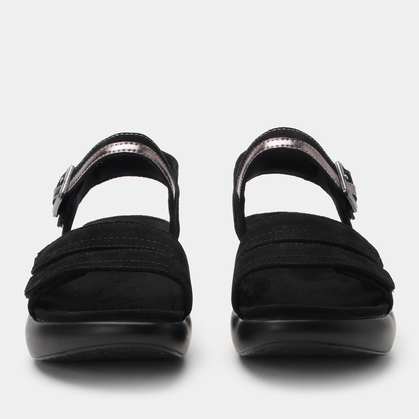 Black sandals with metallic straps on a white background