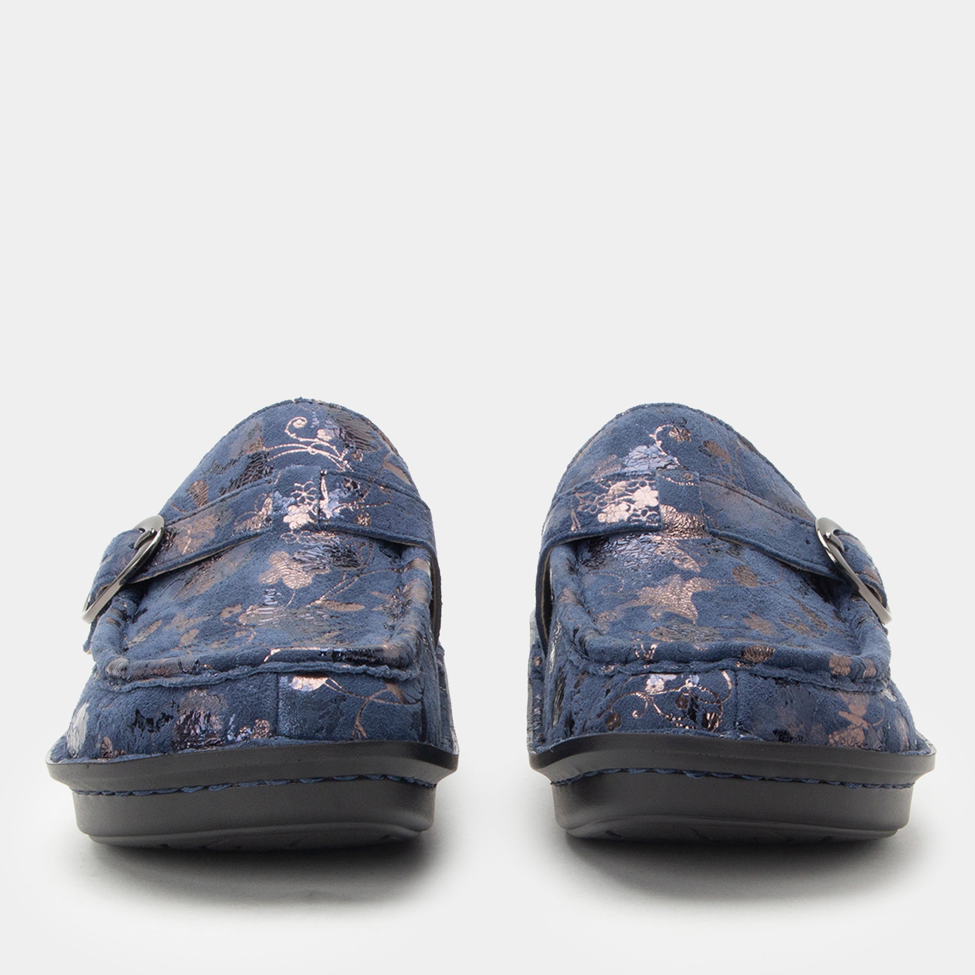 Pair of blue loafers with floral pattern on a white background