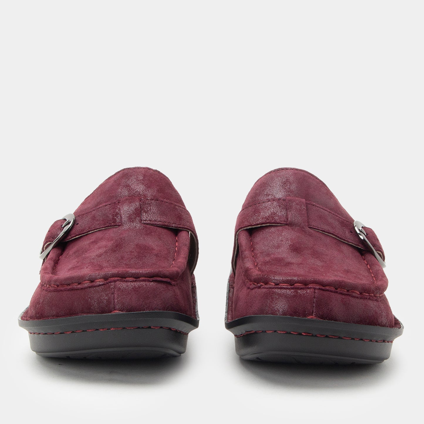 Pair of maroon loafers on a white background