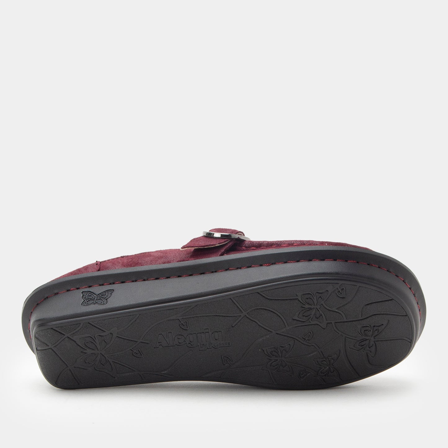 Maroon sandal with a black sole on a white background