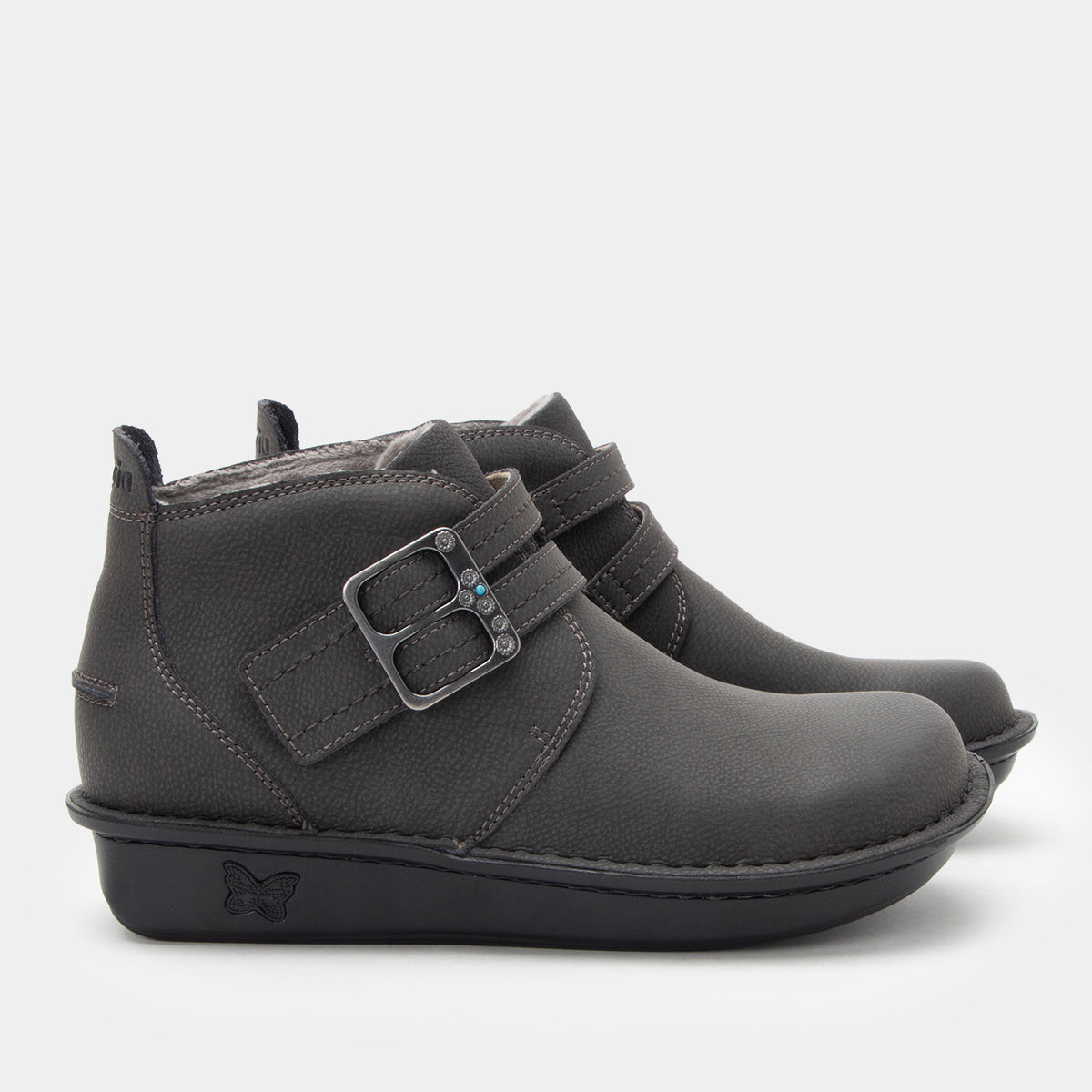 Gray ankle boots with a buckle on a light gray background