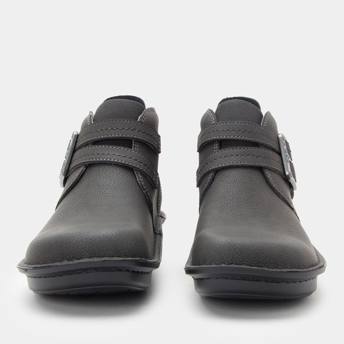 Pair of gray ankle boots with velcro straps on a white background