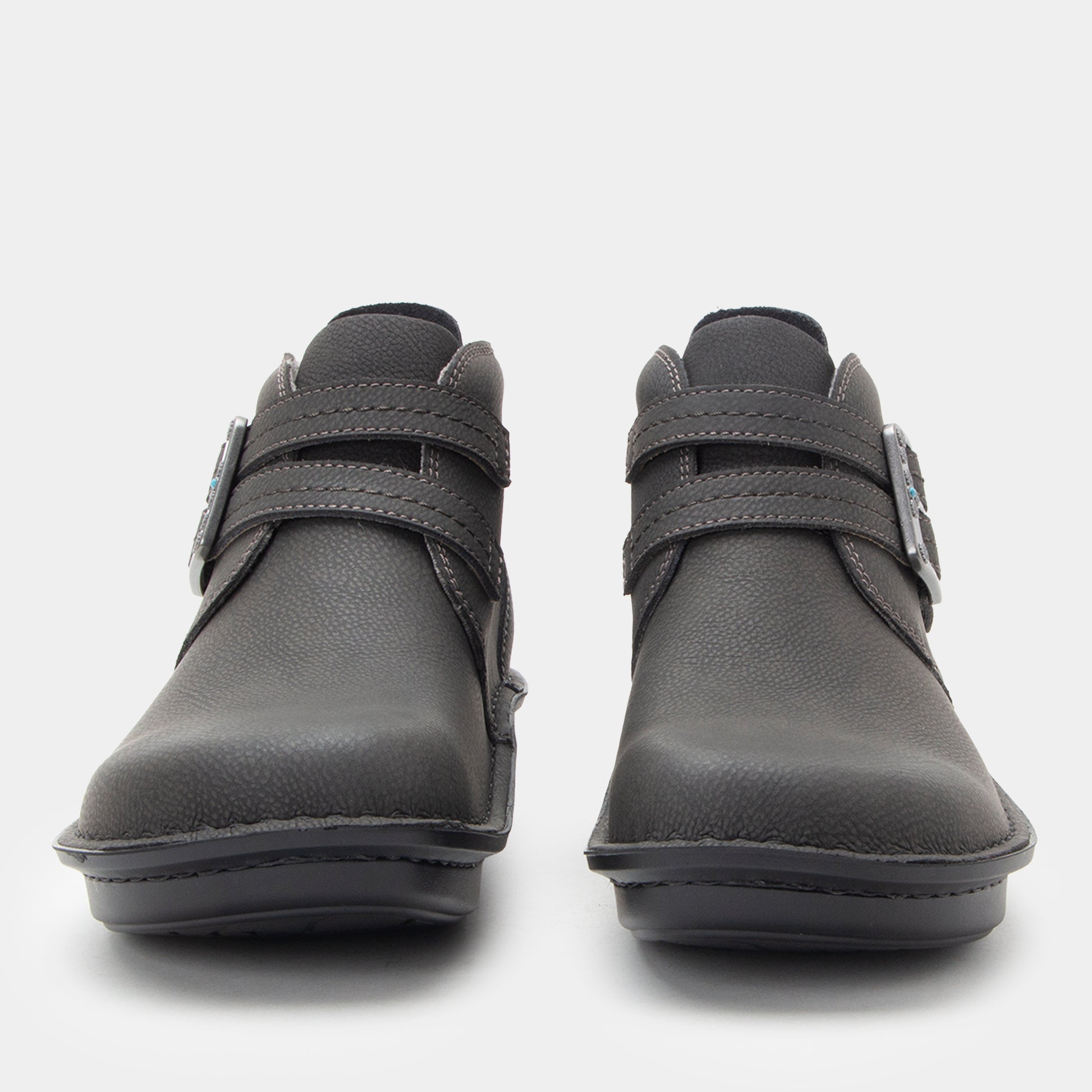 Pair of gray ankle boots with velcro straps on a white background
