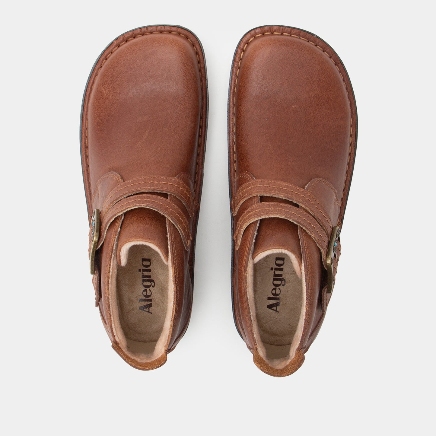 Pair of brown leather shoes with 'Alegria' branding on a white background