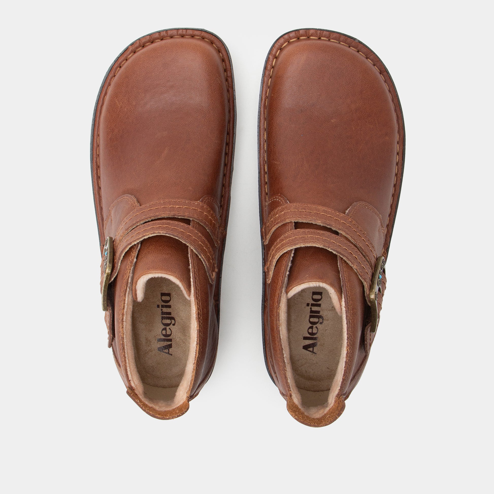 Pair of brown leather shoes with 'Alegria' branding on a white background