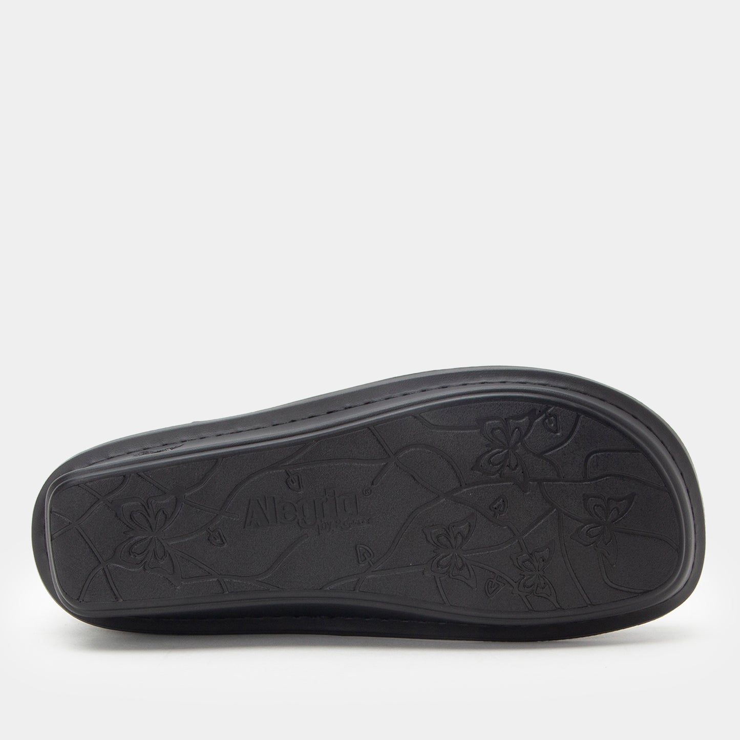 Black sandal sole with brand logo on a light gray background