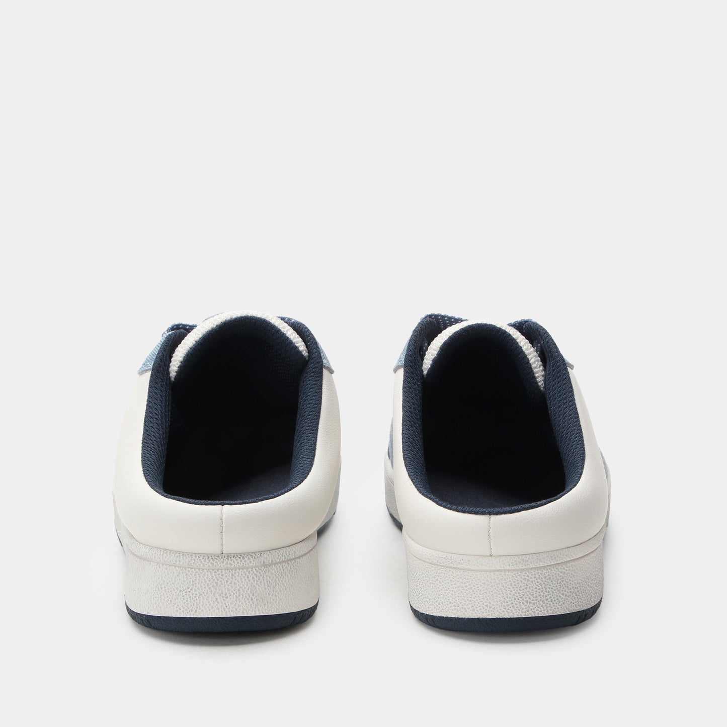 White sneakers with navy accents on a light gray background