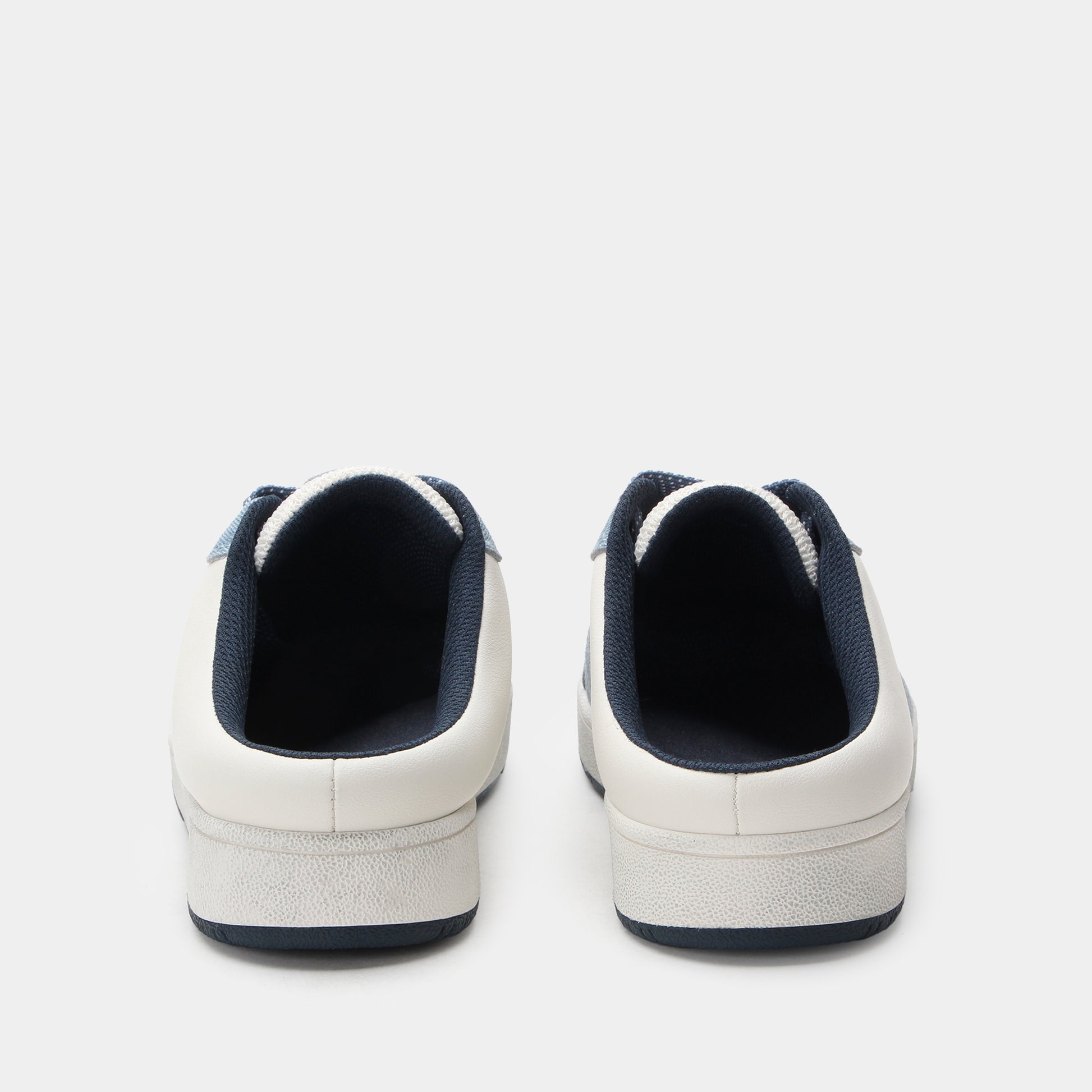 White sneakers with navy accents on a light gray background