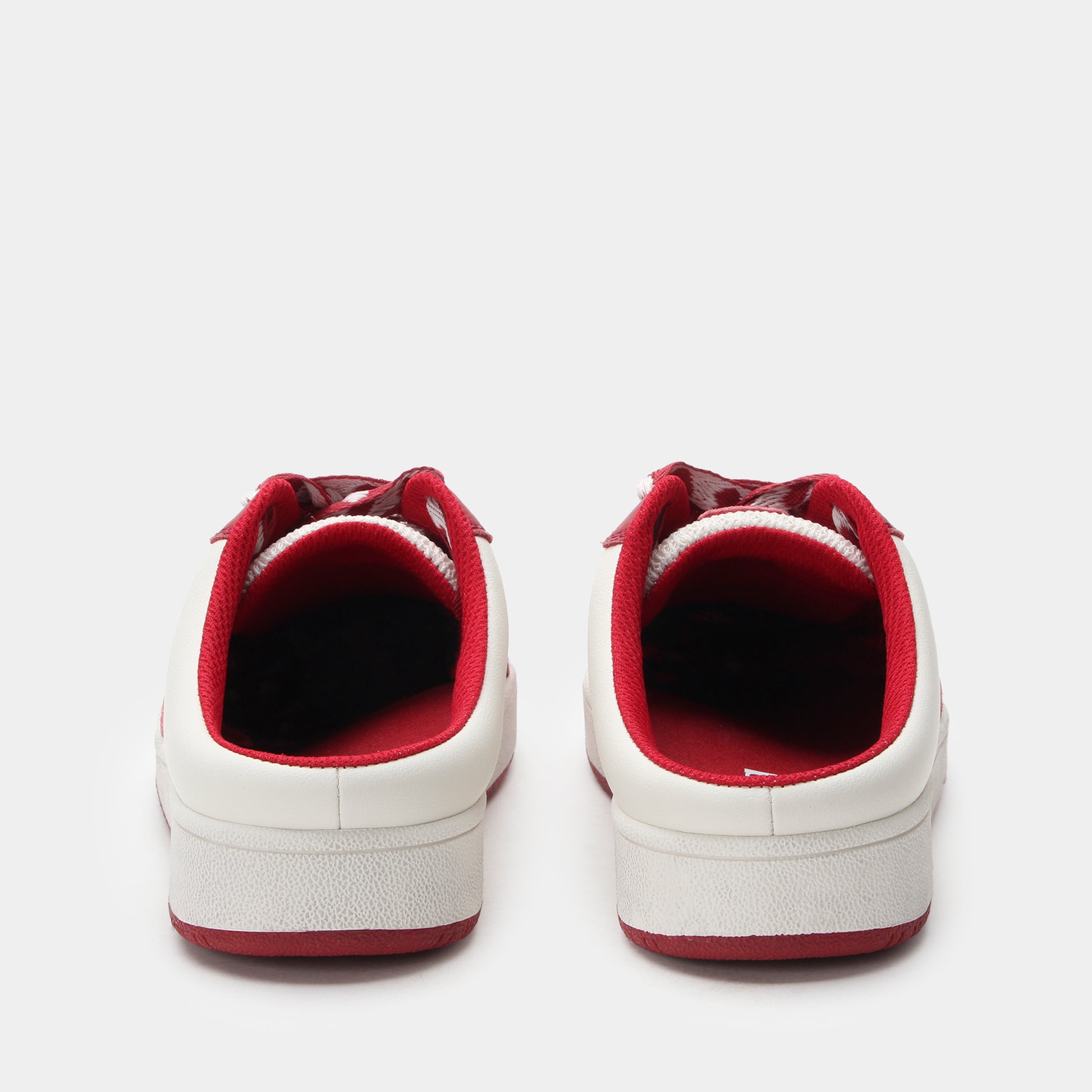 White sneakers with red soles on a white background