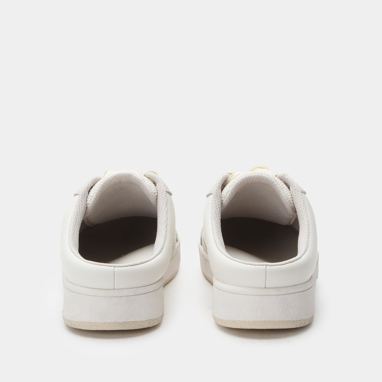 Pair of white sneakers on a light gray background