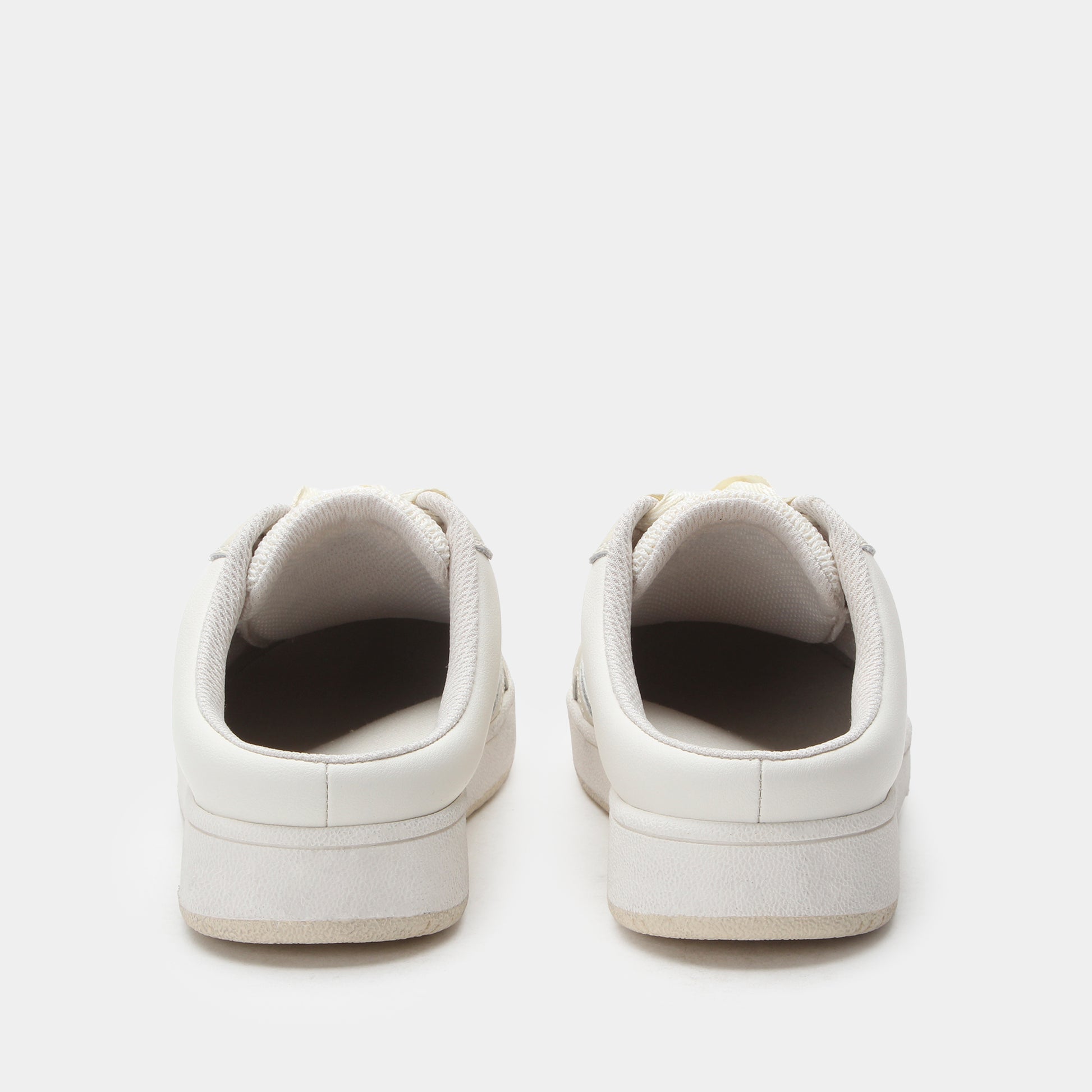 Pair of white sneakers on a light gray background