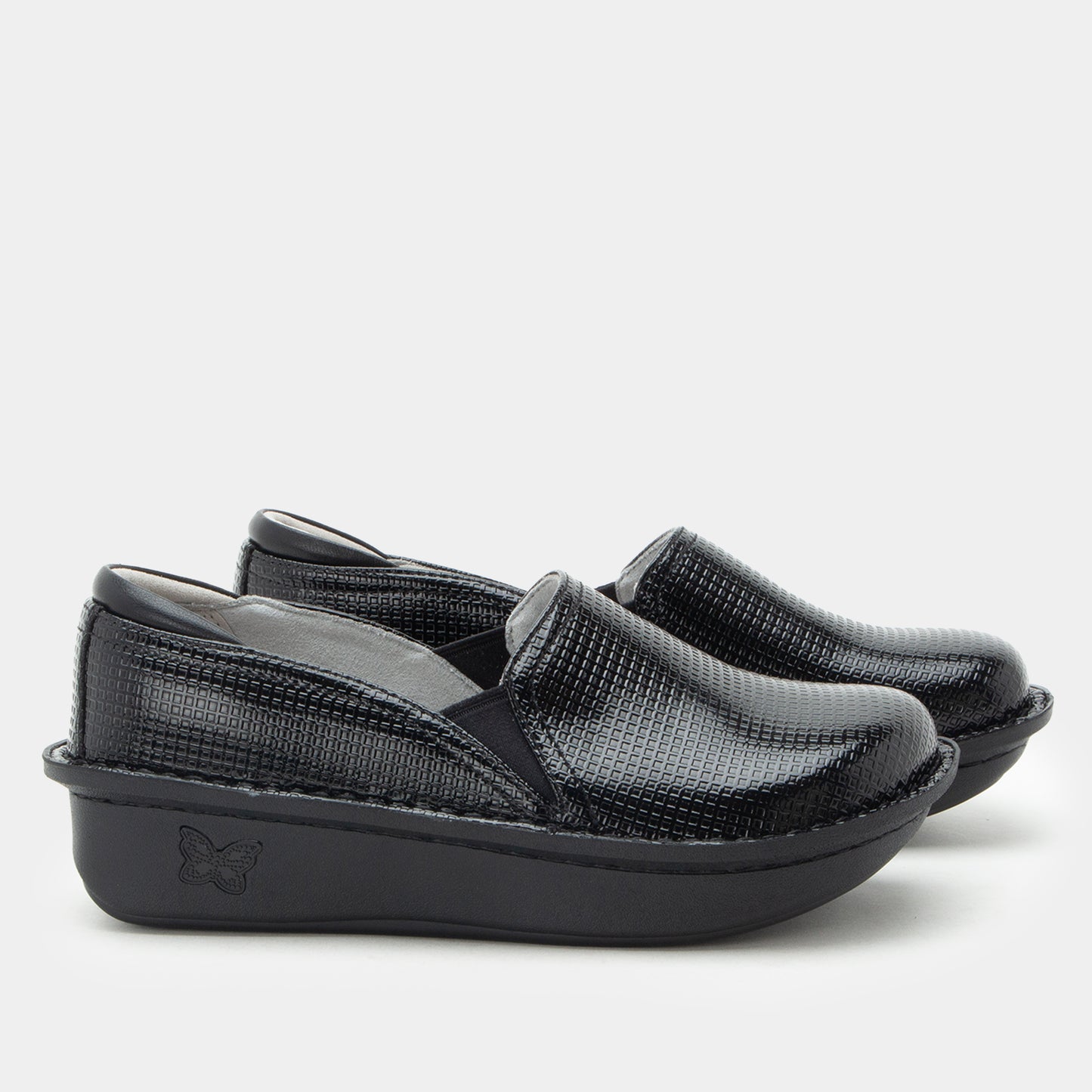 A pair of women's slip-on wedge shoes in black textured faux-croc leather, featuring a thick black platform sole with a debossed butterfly logo, shown against a light gray background.