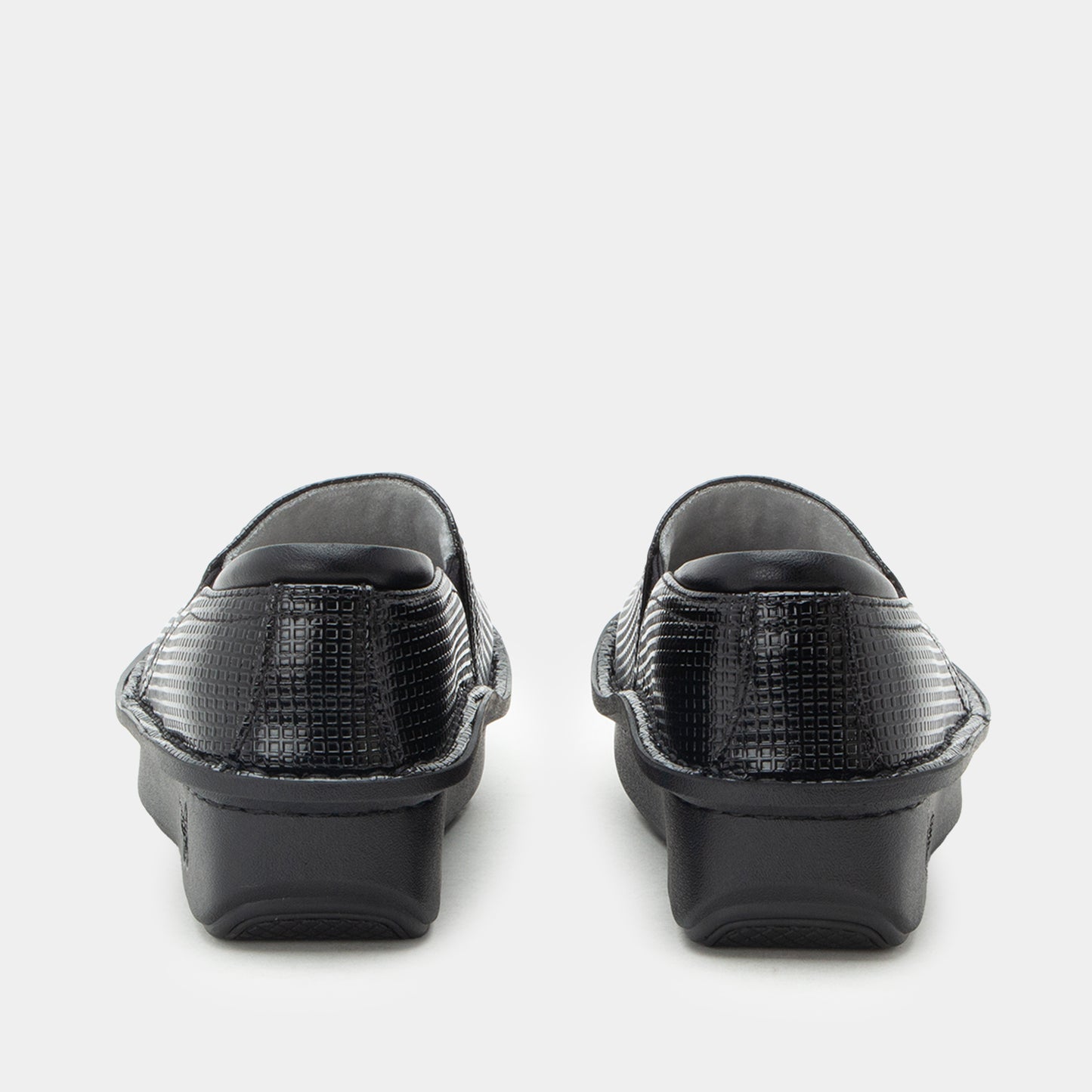 A pair of black slip-on clogs with a textured crocodile-embossed upper and chunky black platform soles, shown from the back on a light gray background.