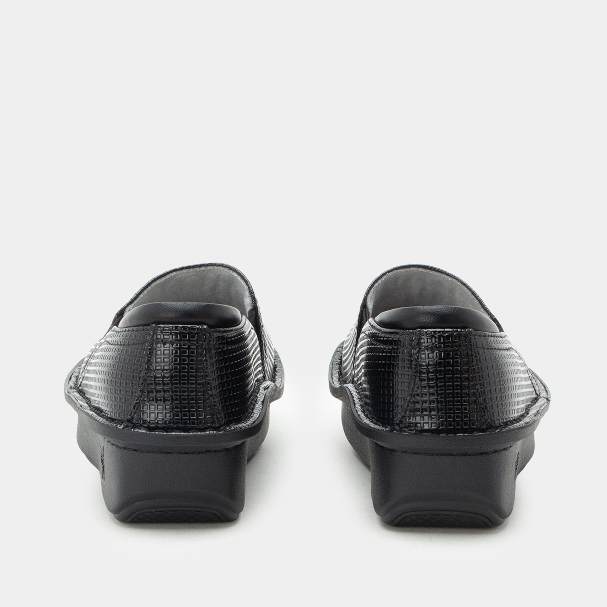 A pair of black slip-on clogs with a textured crocodile-embossed upper and chunky black platform soles, shown from the back on a light gray background.