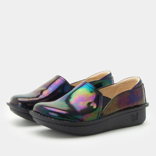 A pair of slip-on platform shoes with an iridescent, holographic finish showing purple, green, and blue tones, set against a plain light gray background.