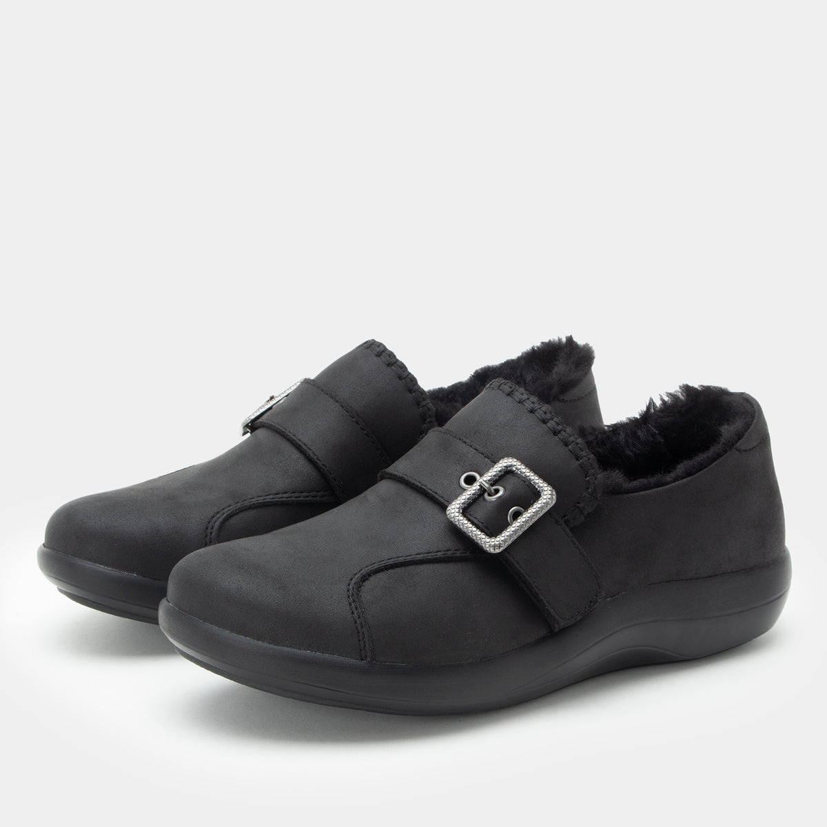 A pair of Alegria shoes in a black color, set against a plain light gray background.