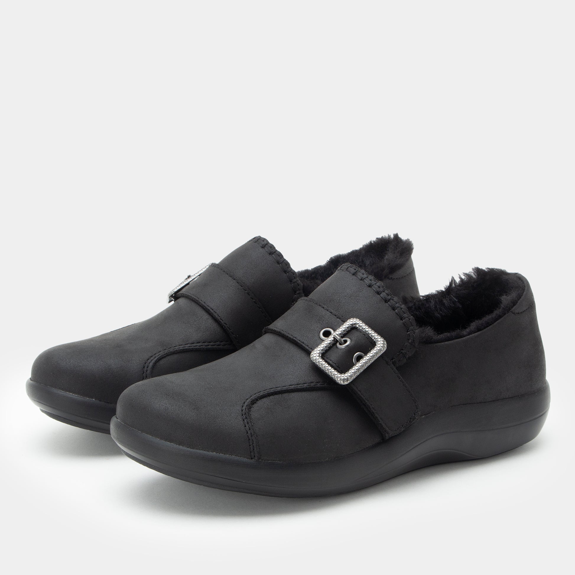 A pair of Alegria shoes in a black color, set against a plain light gray background.