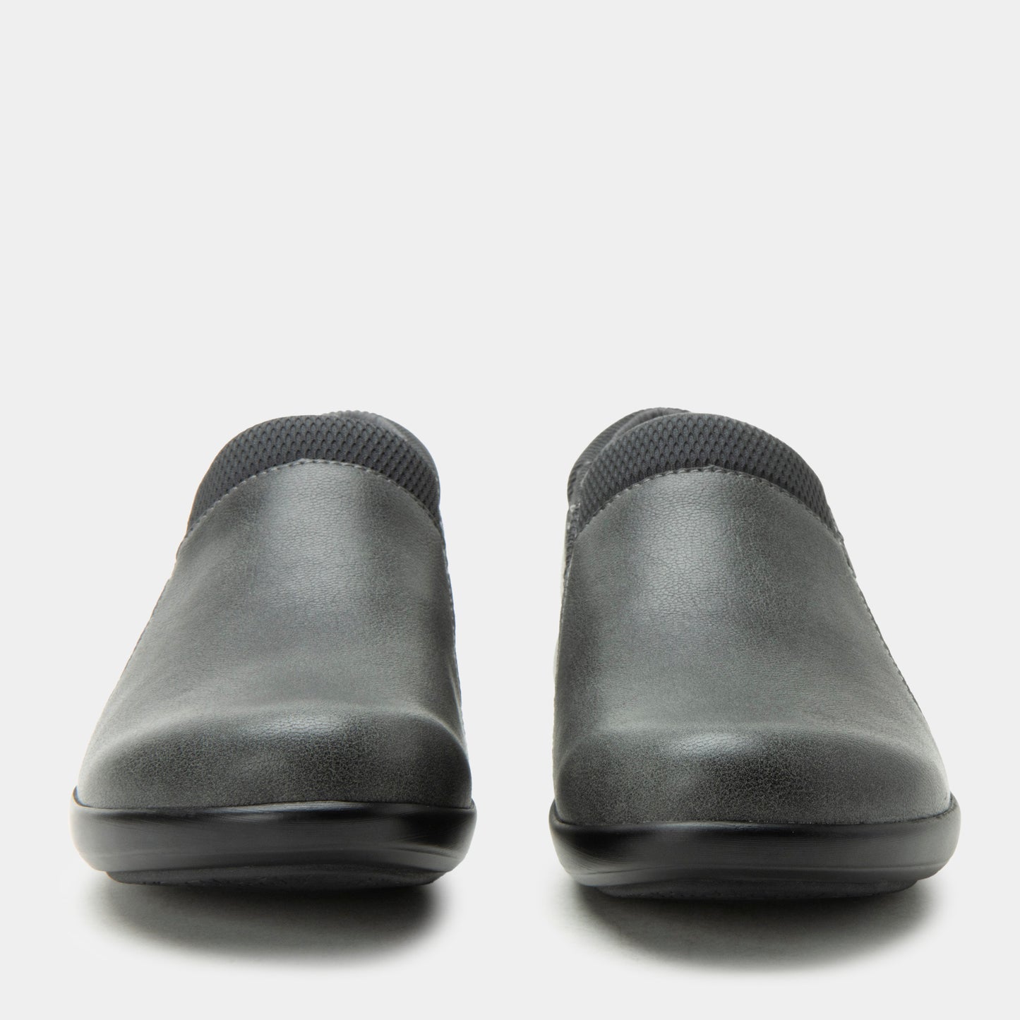 Pair of black slip-on shoes on a white background